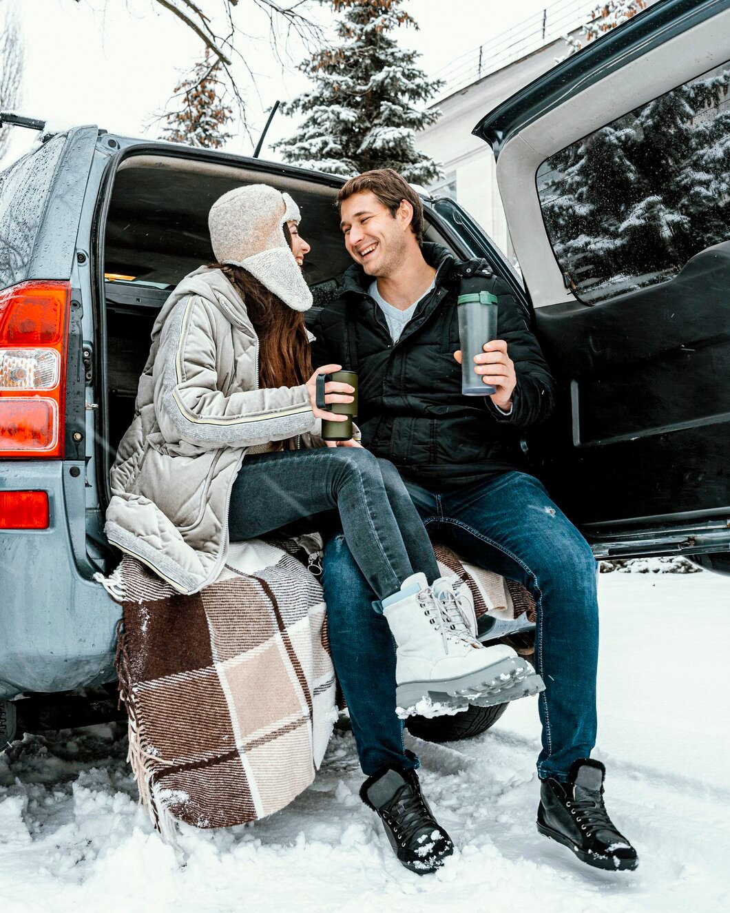 low-angle-happy-couple-having-warm-drink-car-s-trunk-while-road-trip_23-2148851159.jpg