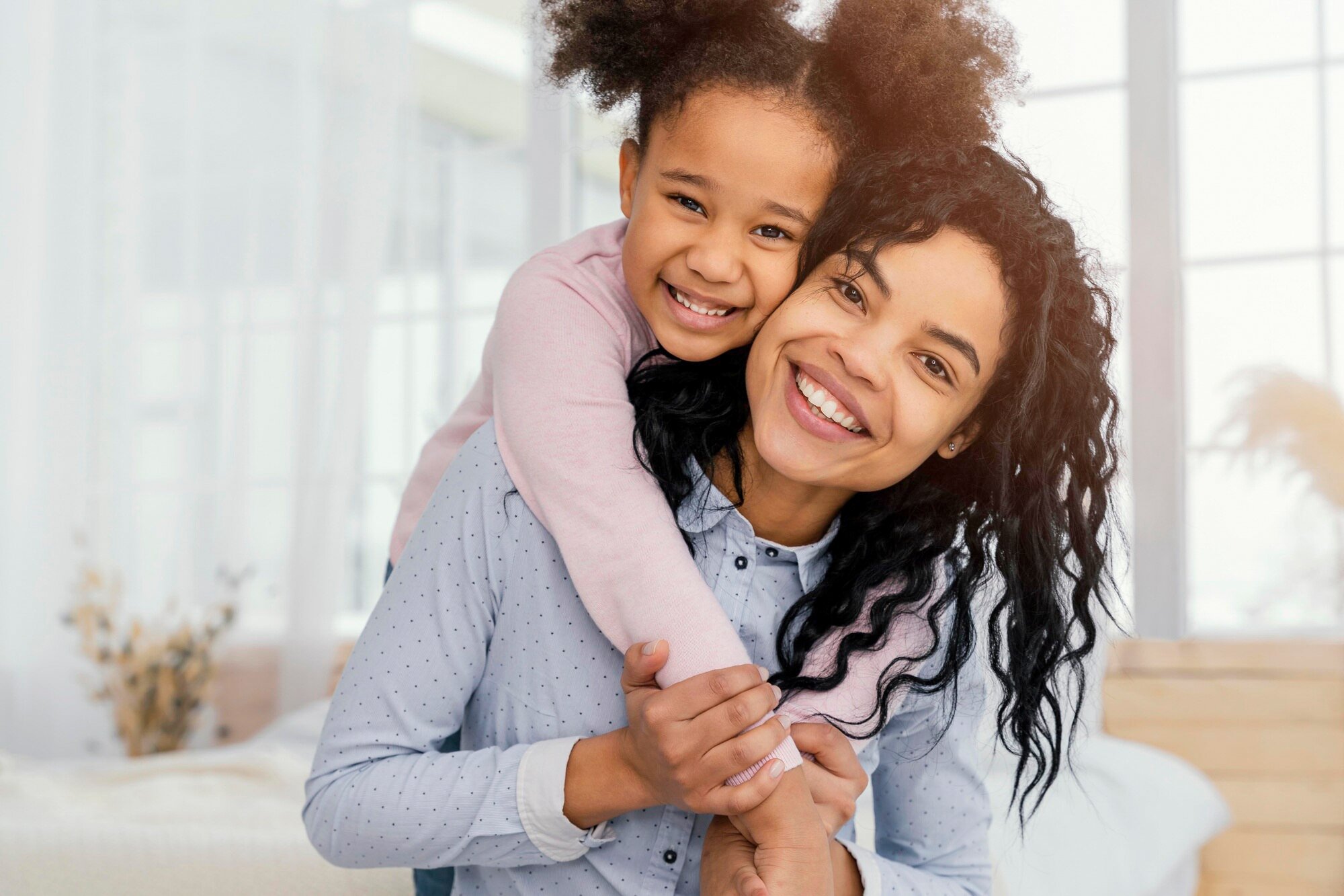 front-view-mother-playing-home-with-her-daughter_23-2148890962.jpg