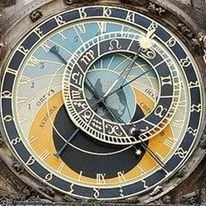 Close-up of an astronomical clock with multiple dials and intricate details.