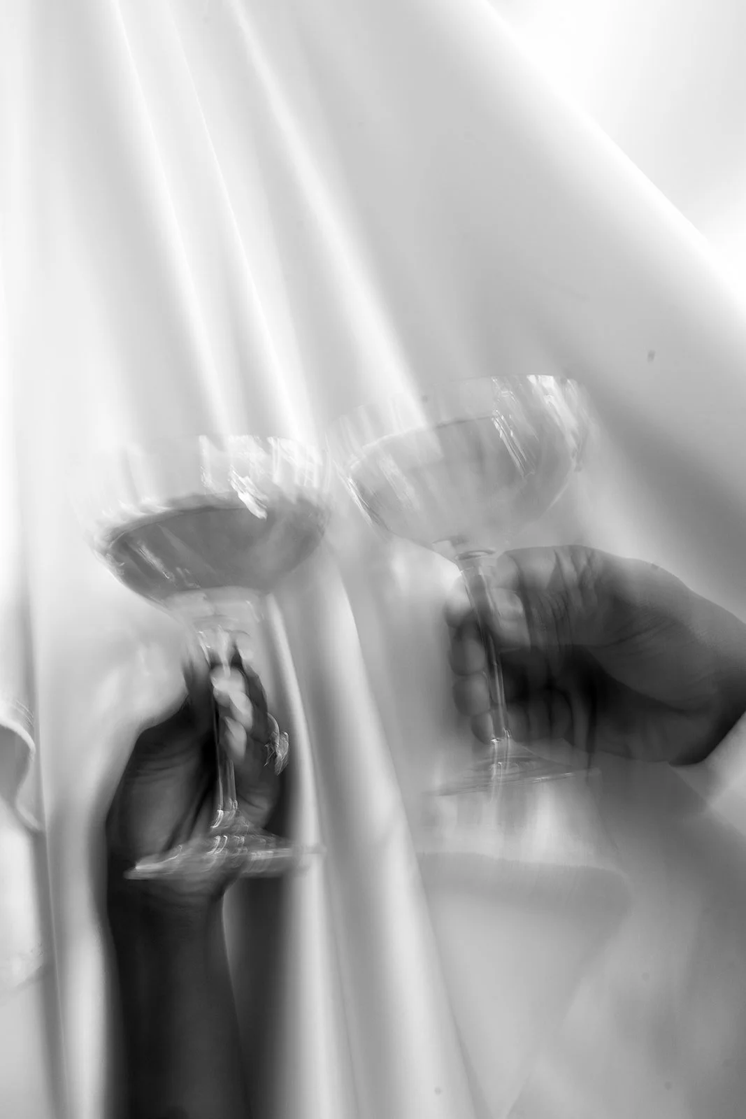 two champagne glasses clinking together in celebratory