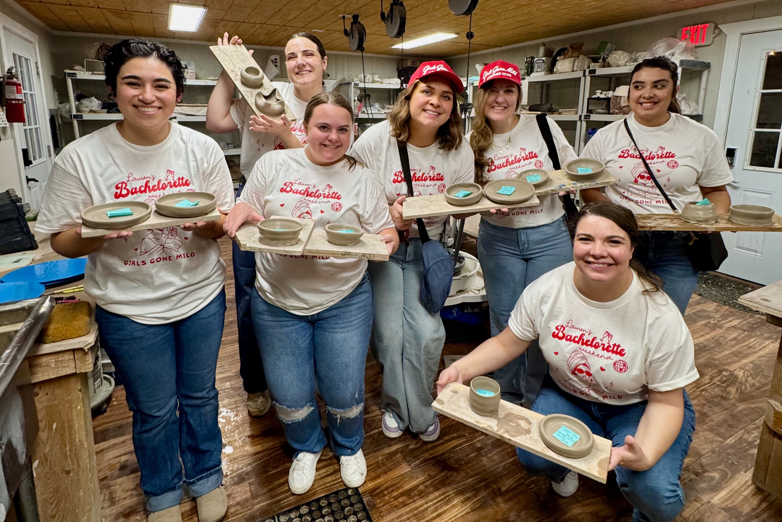 Group of women in a workshop holding trays with ceramic pottery they made, wearing matching t-shirts and hats, smiling for the photo.
	•	pottery birthday party Frisco TX
	•	private pottery class near me
	•	pottery party for adults and kids
	•	bachelo