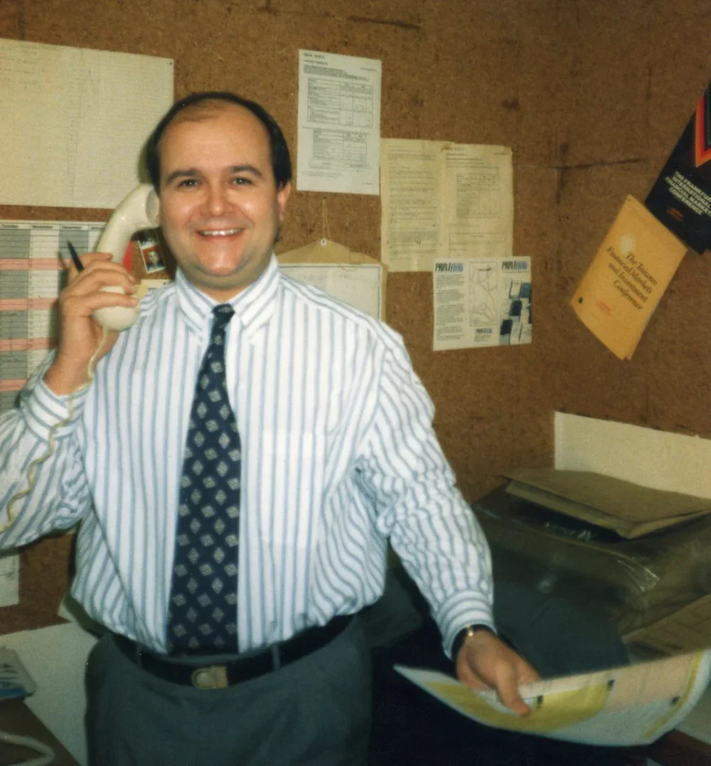 Les Manning, founder of Rapidity pictured here in the 1990's. Pin stripe shirt with patterned tie holding an old fashioned landline phone