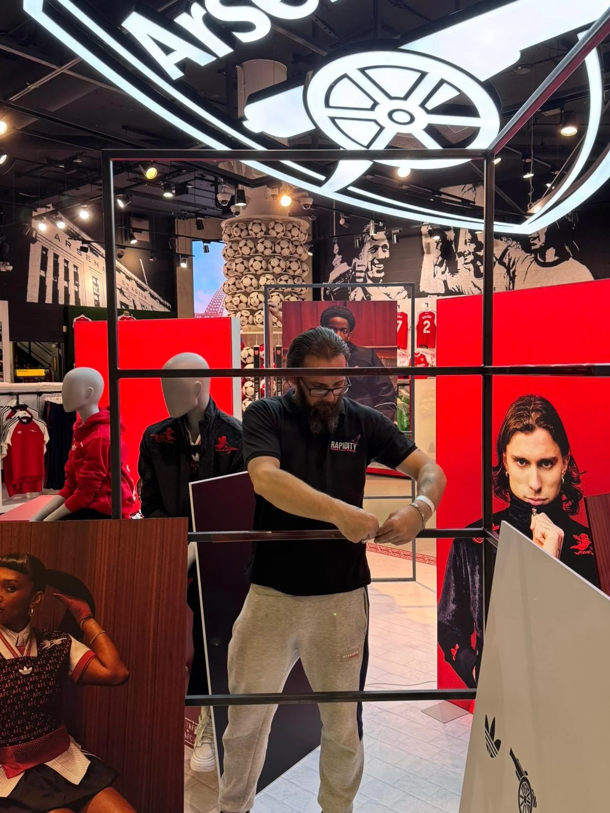 Rapidity staff installing graphics system onsite at customers retail shop