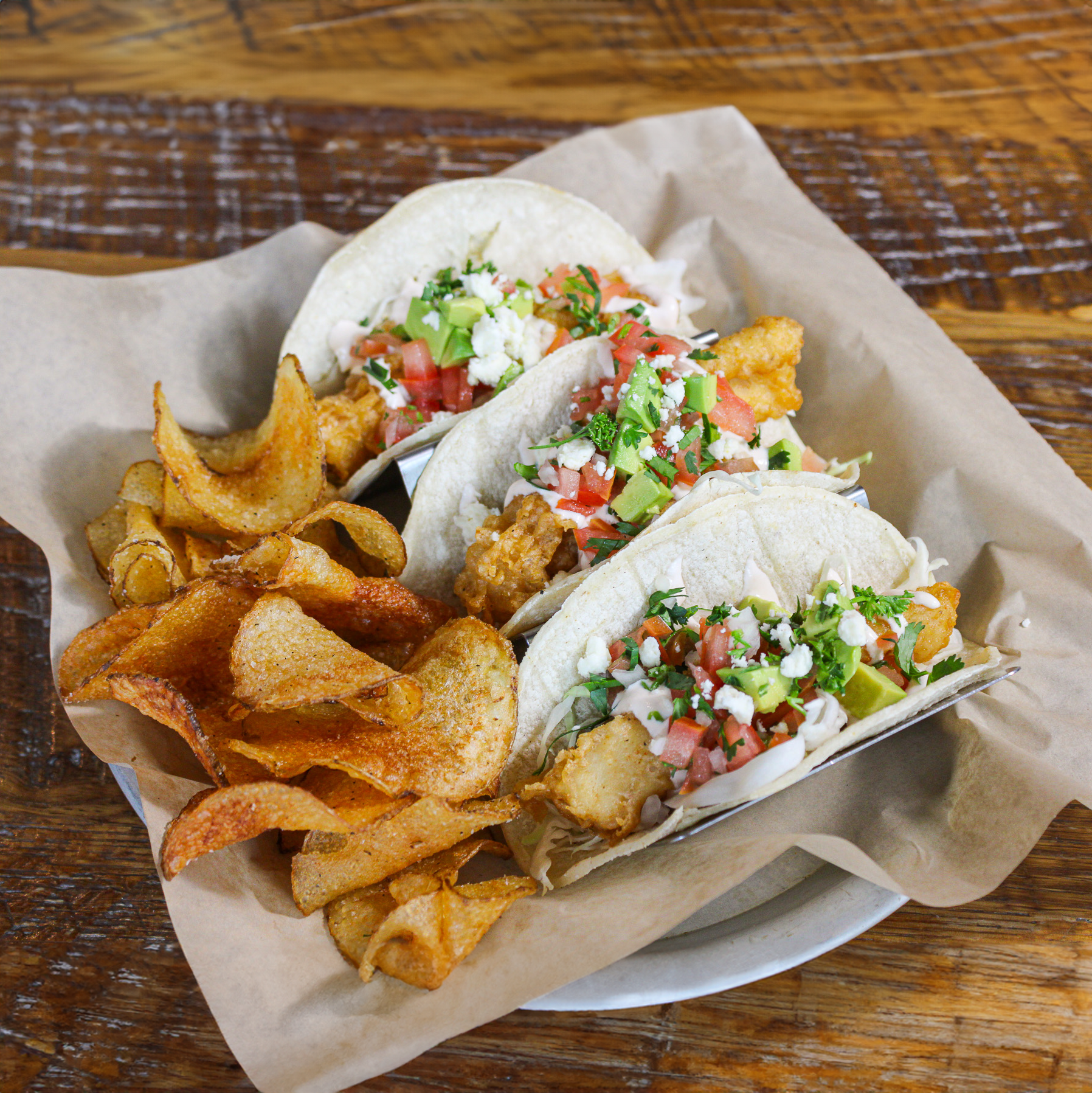 Official Sixpoint Brewery photo of a plate of tacos and chips.