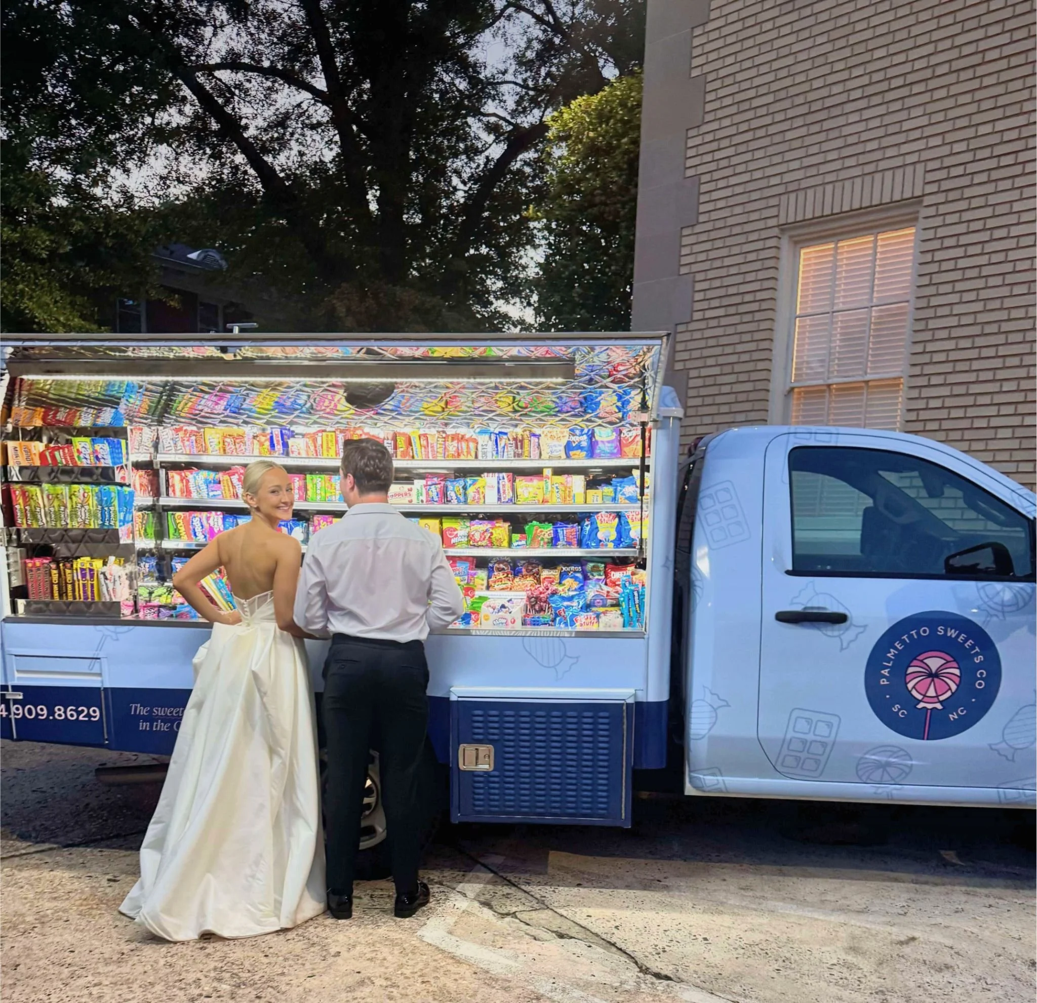 Bride and groom enjoying a wedding candy bar and late-night snack experience by Palmetto Sweets Co.