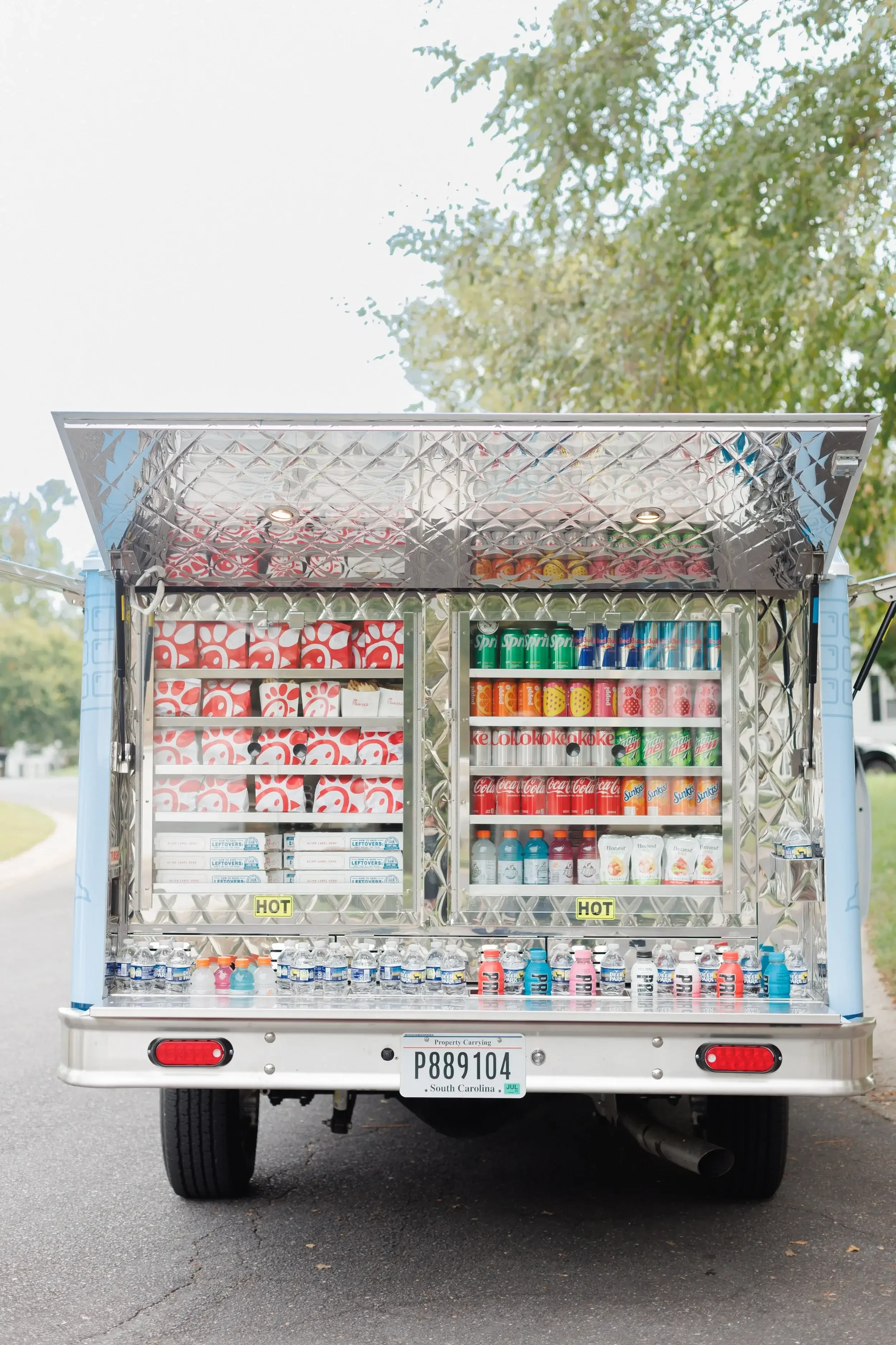 Palmetto Sweets Co. beverage concession truck rear view showing refrigerated soft drinks and water bottles with South Carolina license plate