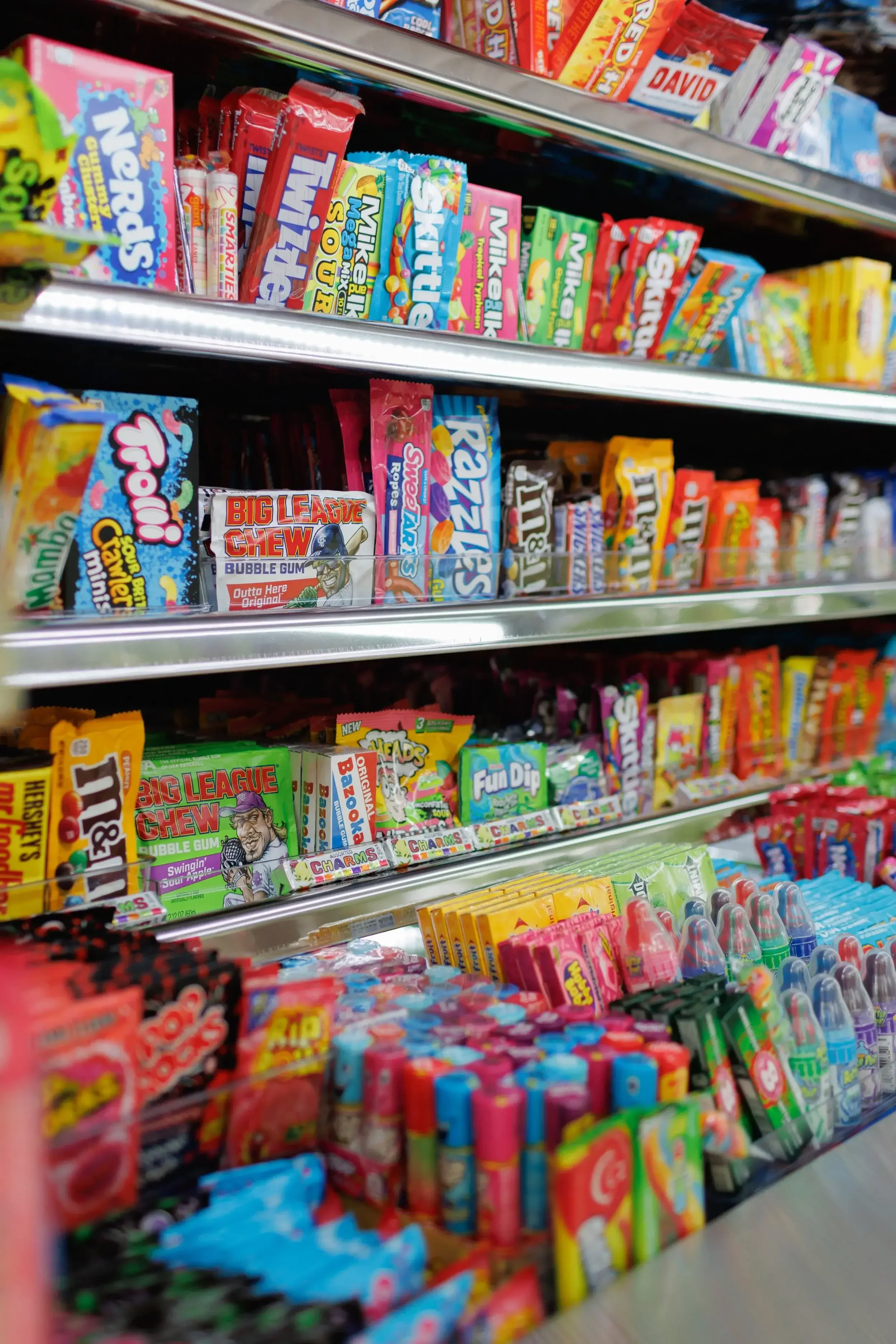 Close-up of candy selection inside Palmetto Sweets Co. truck showing Nerds, Skittles, Big League Chew, and 170+ candy varieties