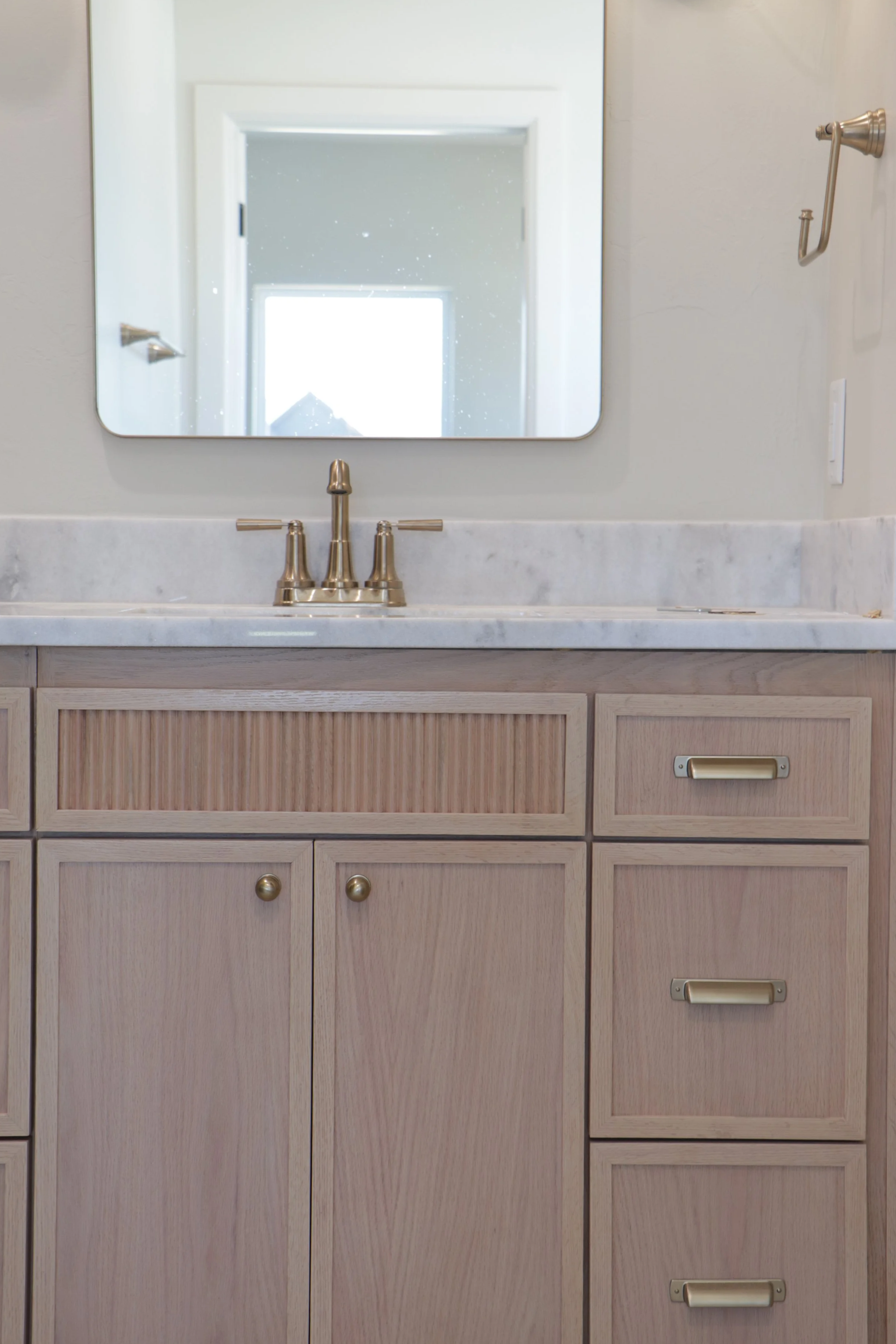 Custom bathroom cabinet with shaker doors and reeded drawer front in OKC.