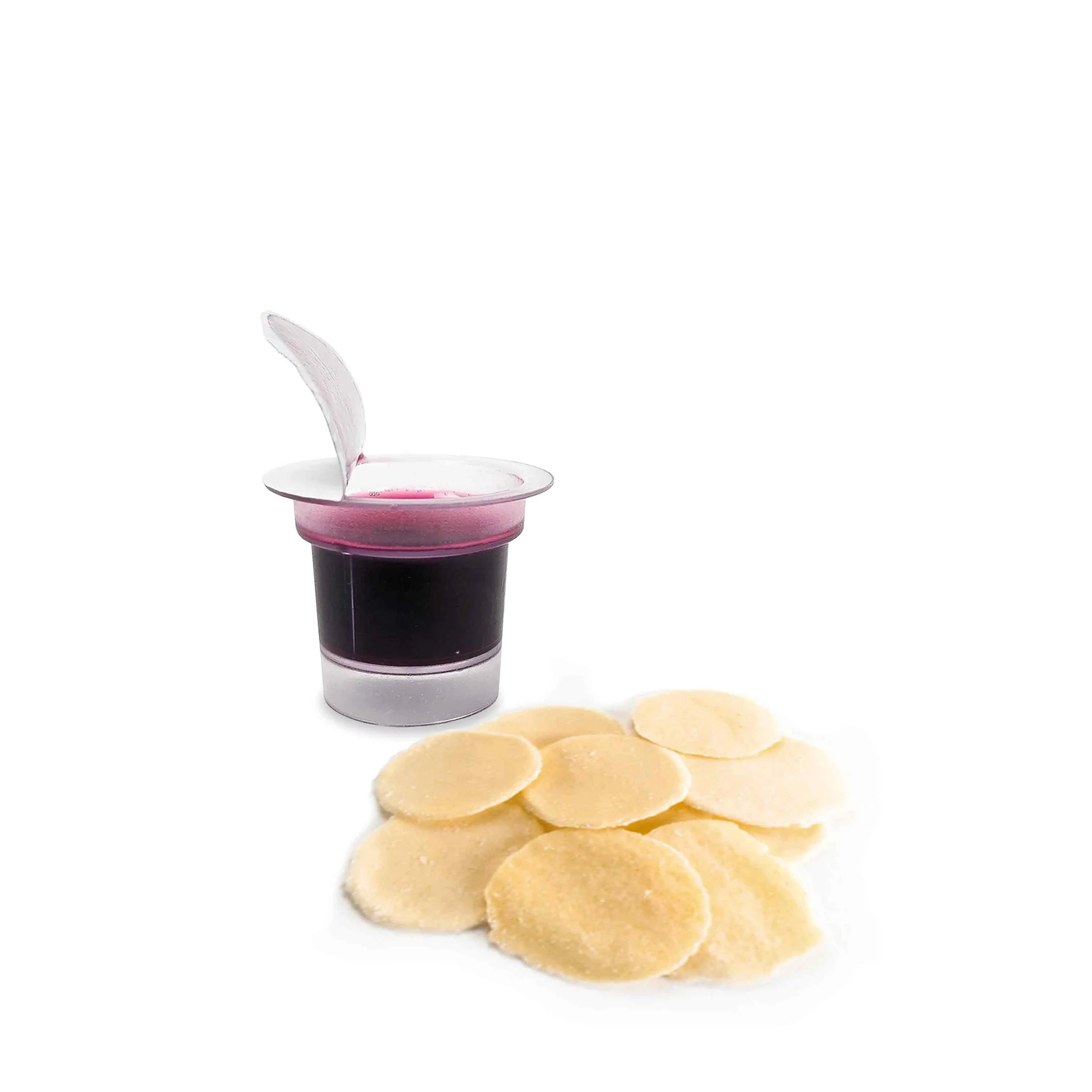 A tiny cup of black coffee with a pink rim, a white plastic lid open, placed next to several potato chips on a white background.