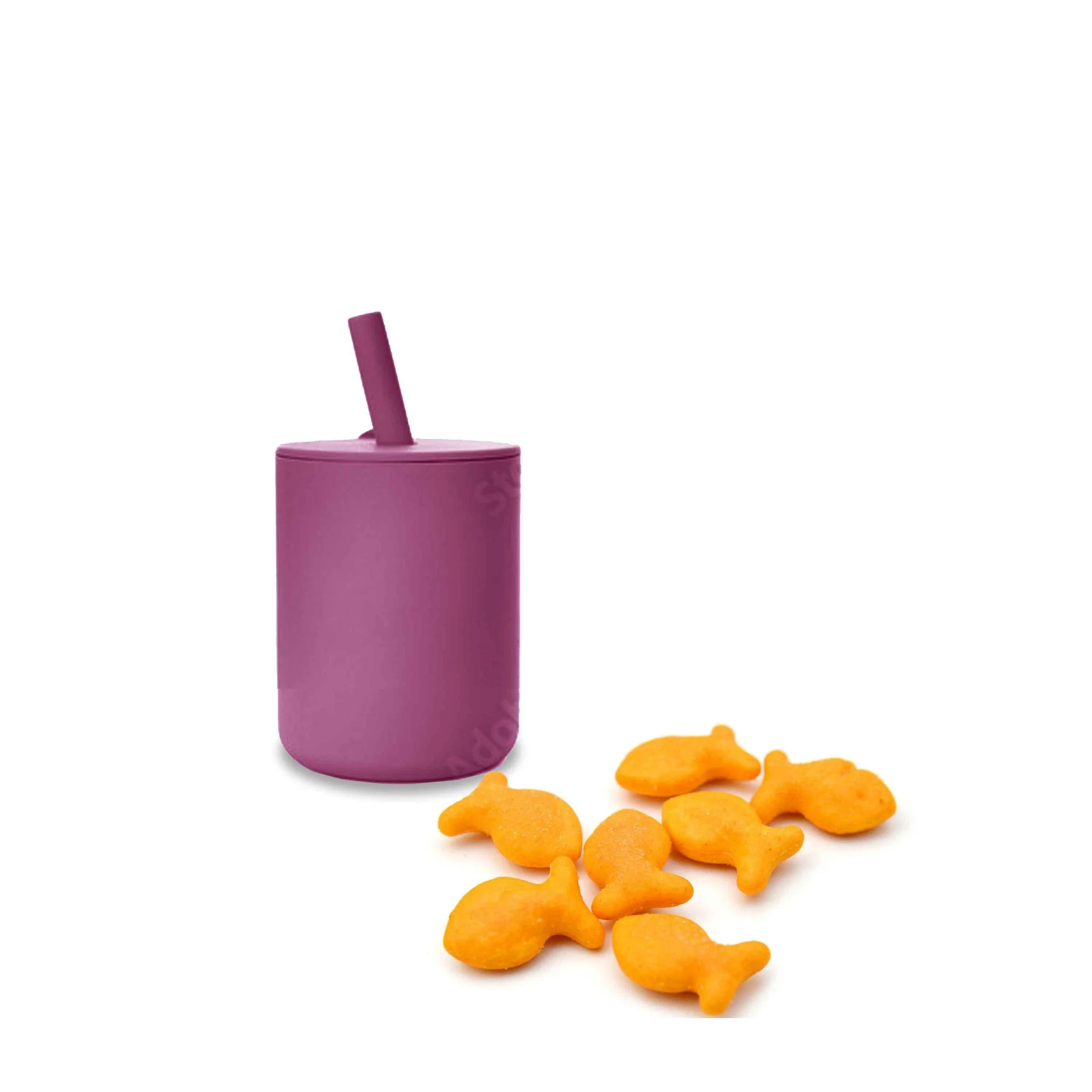 A purple squeeze bottle with a straw and several goldfish-shaped cheese crackers on a white background.