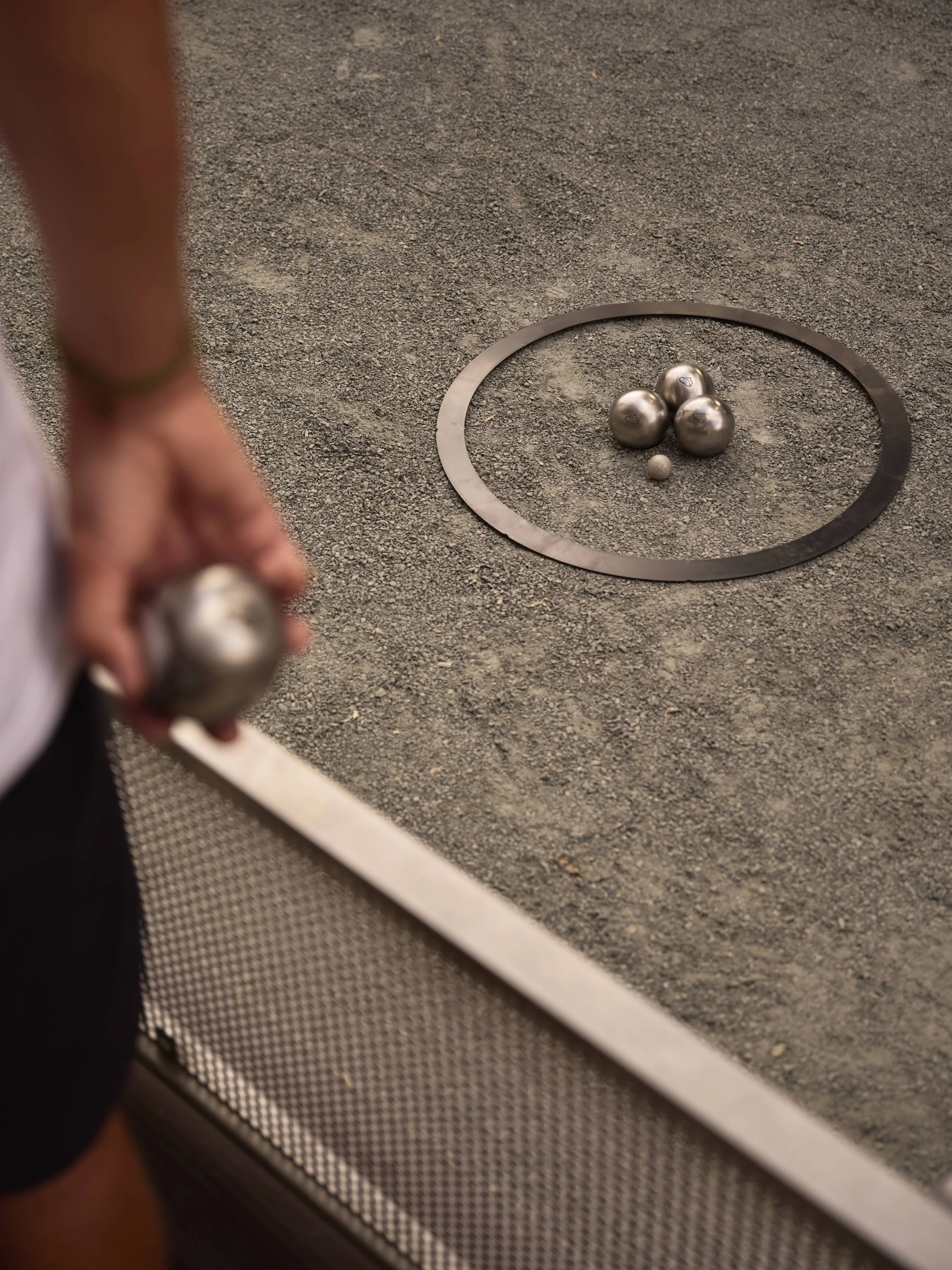 Close-up of pétanque boules on the piste at circle13