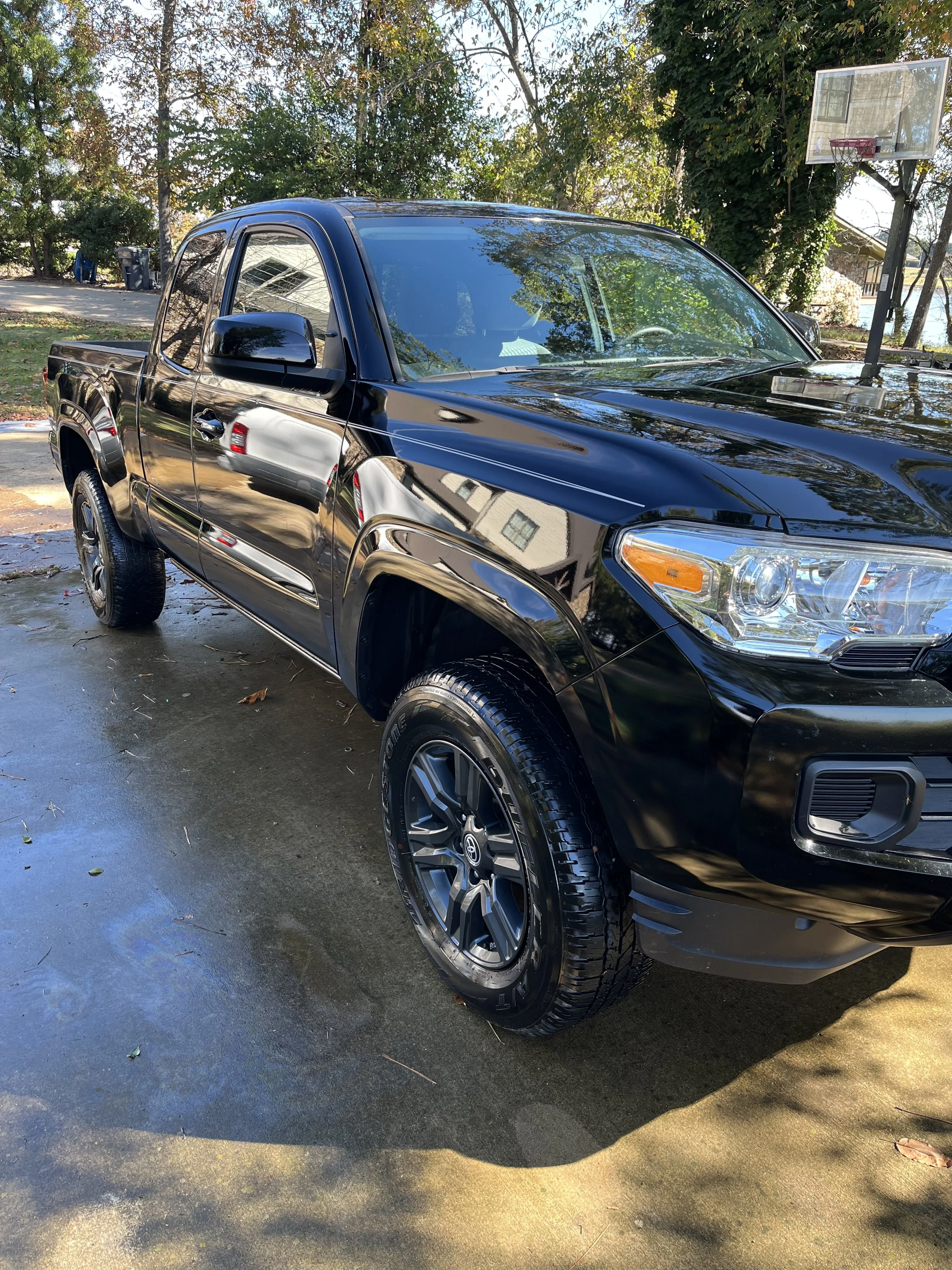 Black pickup truck after professional exterior auto detailing, showcasing a clean and glossy finish.