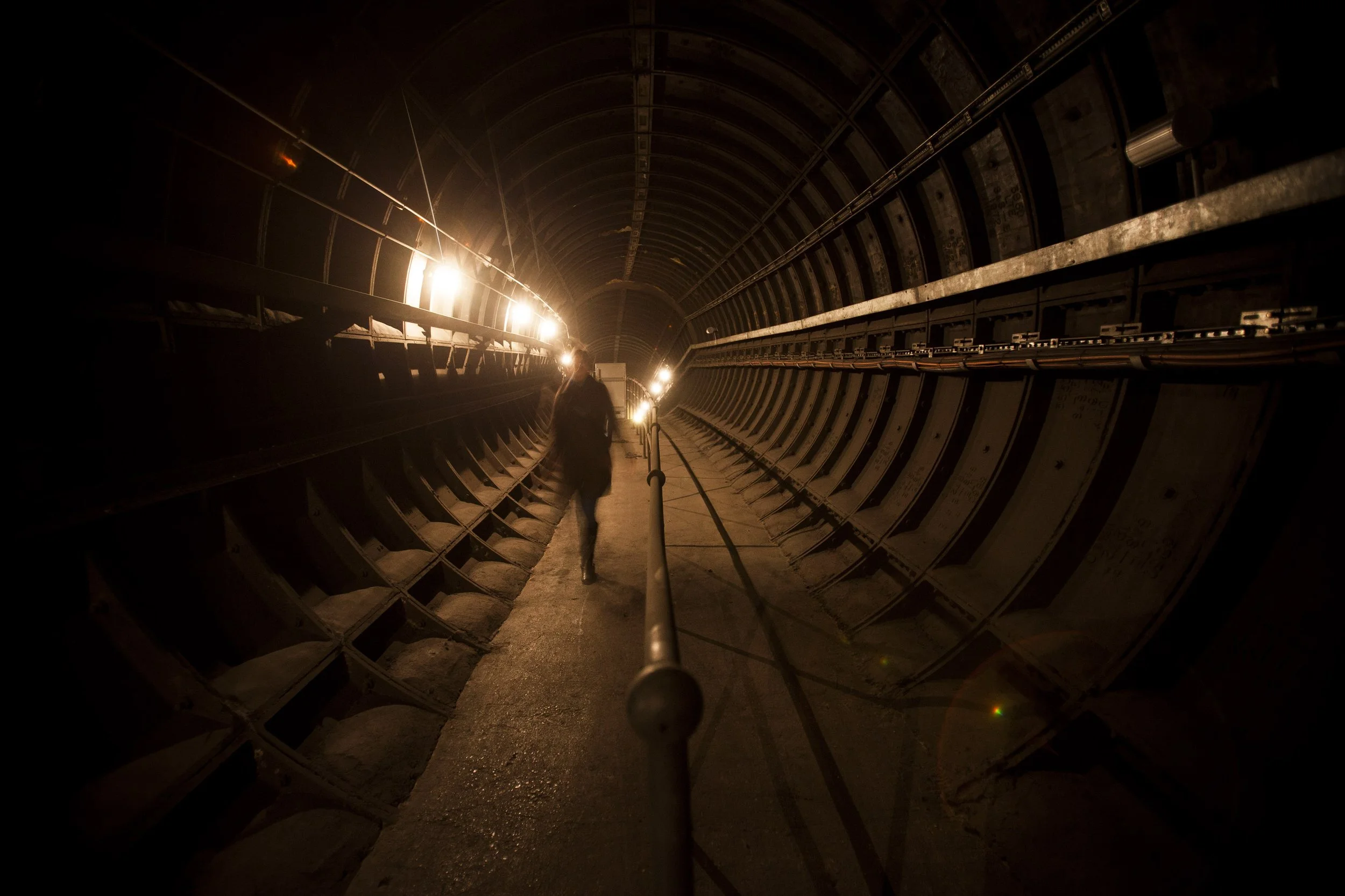 A hidden disused London Underground passageway, dimly lit and closed to the public
