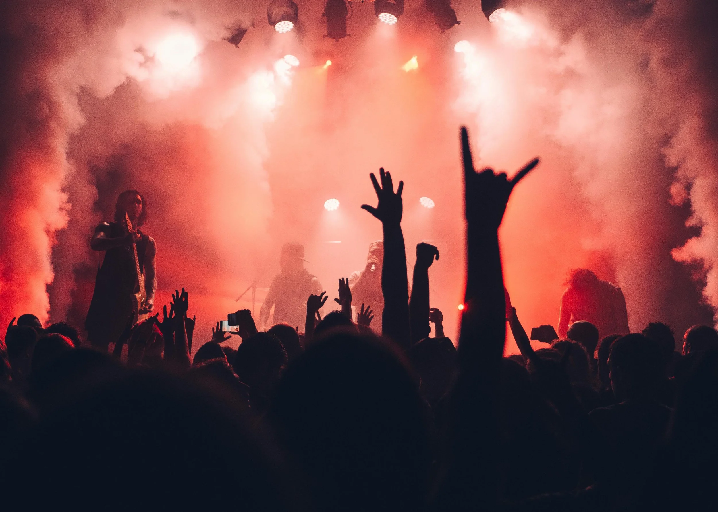 A crowd bathed in stage light at a live concert