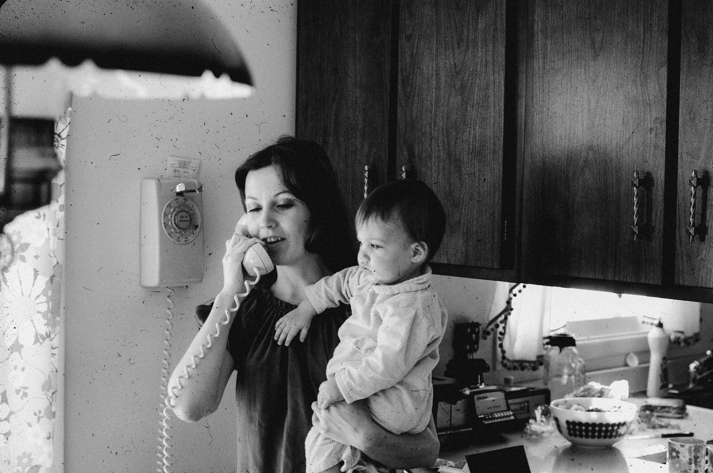 mom talking on the phone while holding her child