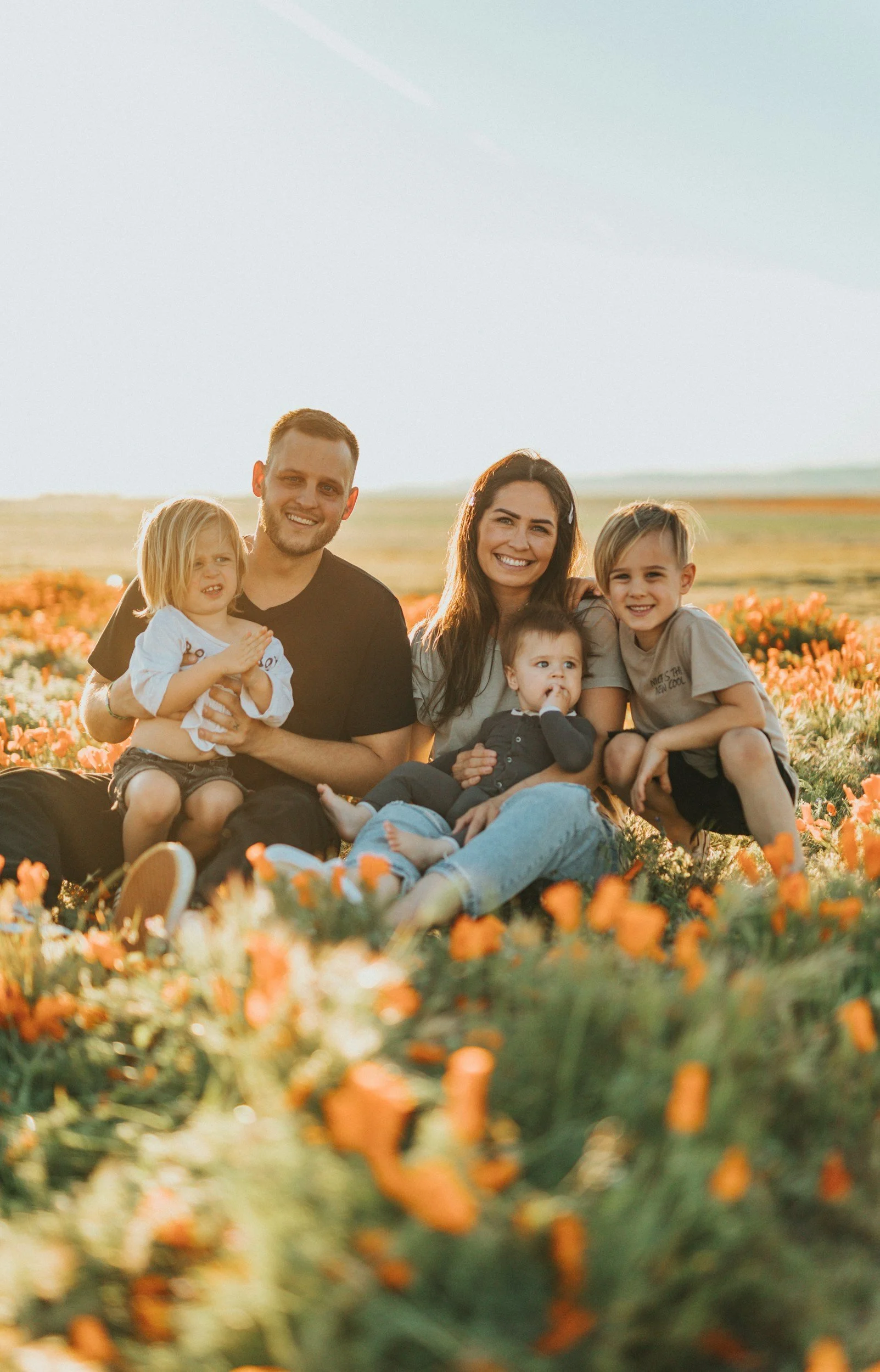 Family taking family photos in a field of flowers