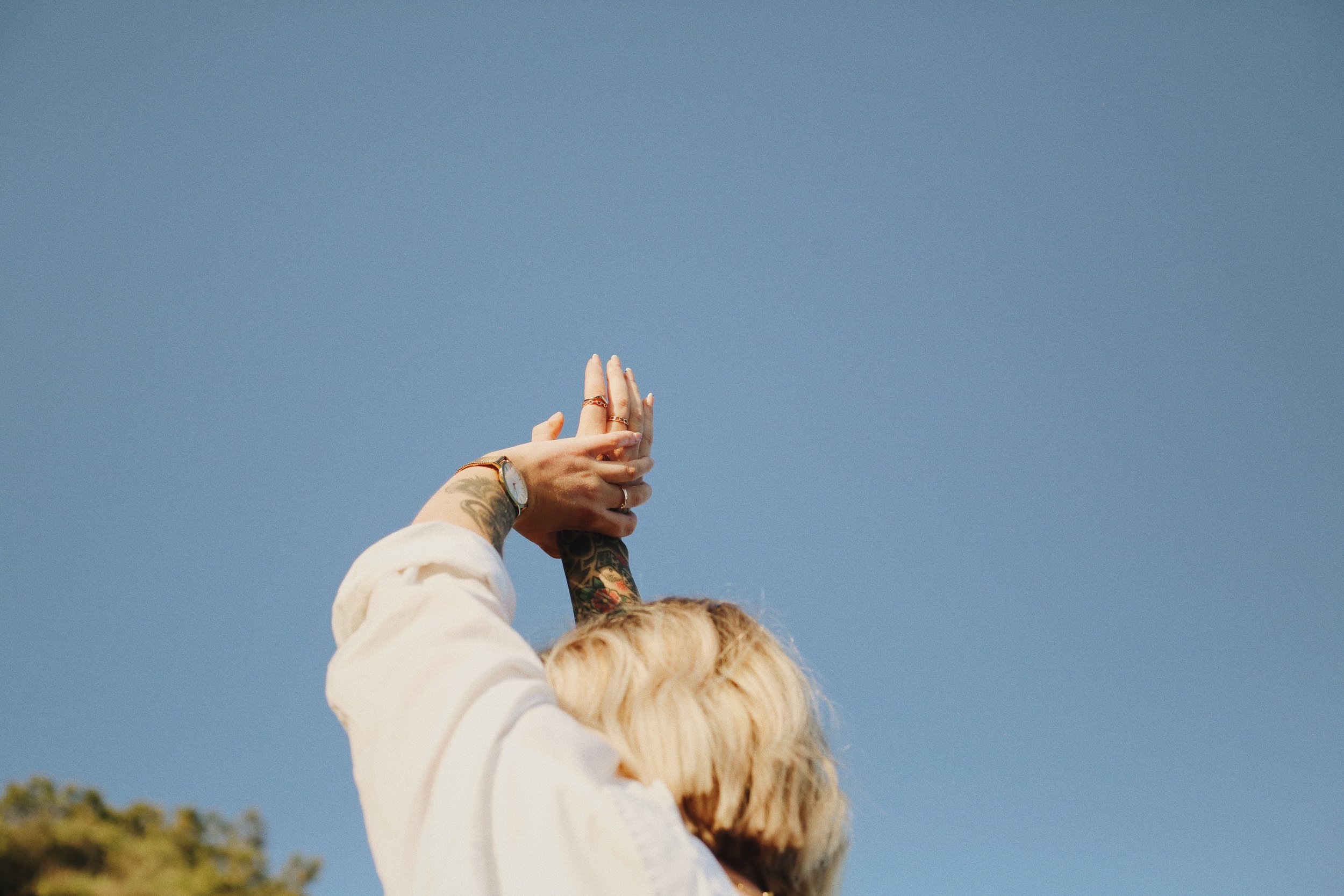 a woman lifting her hands in surrender to God