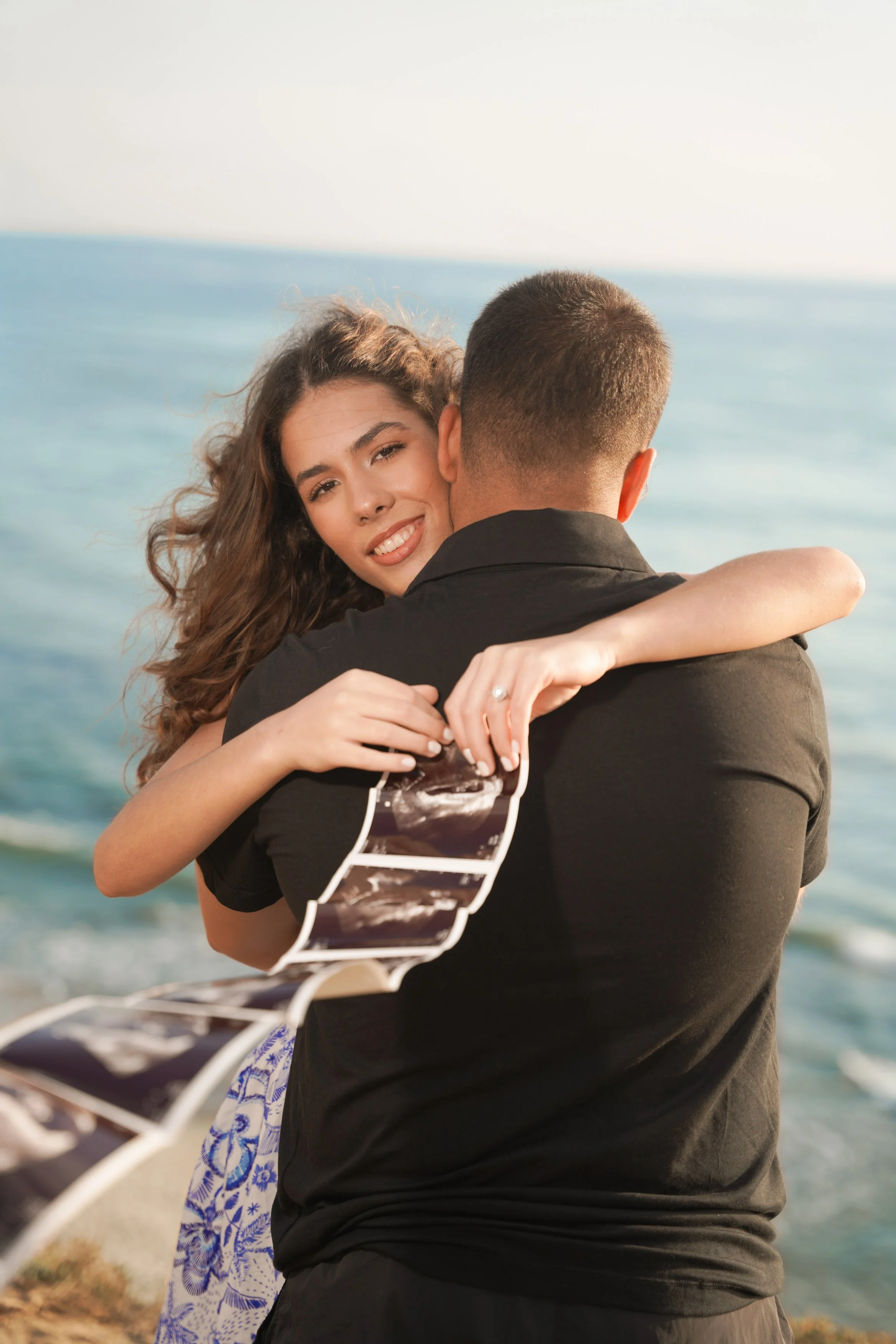 Sunset Cliffs San Diego baby announcement photoshoot during golden hour with stunning coastal skies, crashing waves, and breathtaking scenery, reserve your professional reveal photography today.