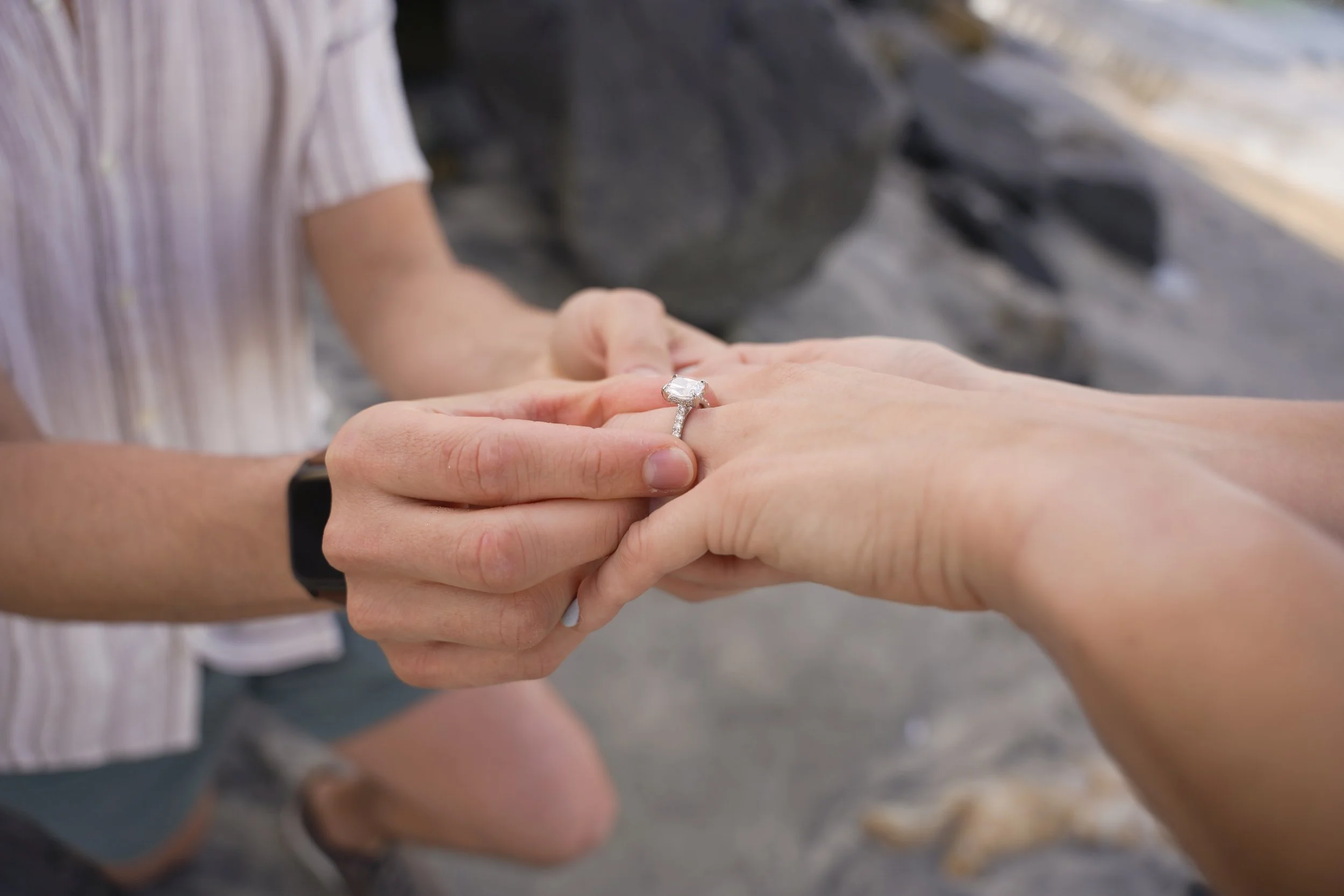 Surprise proposal captured at the moment of kneeling during an engagement