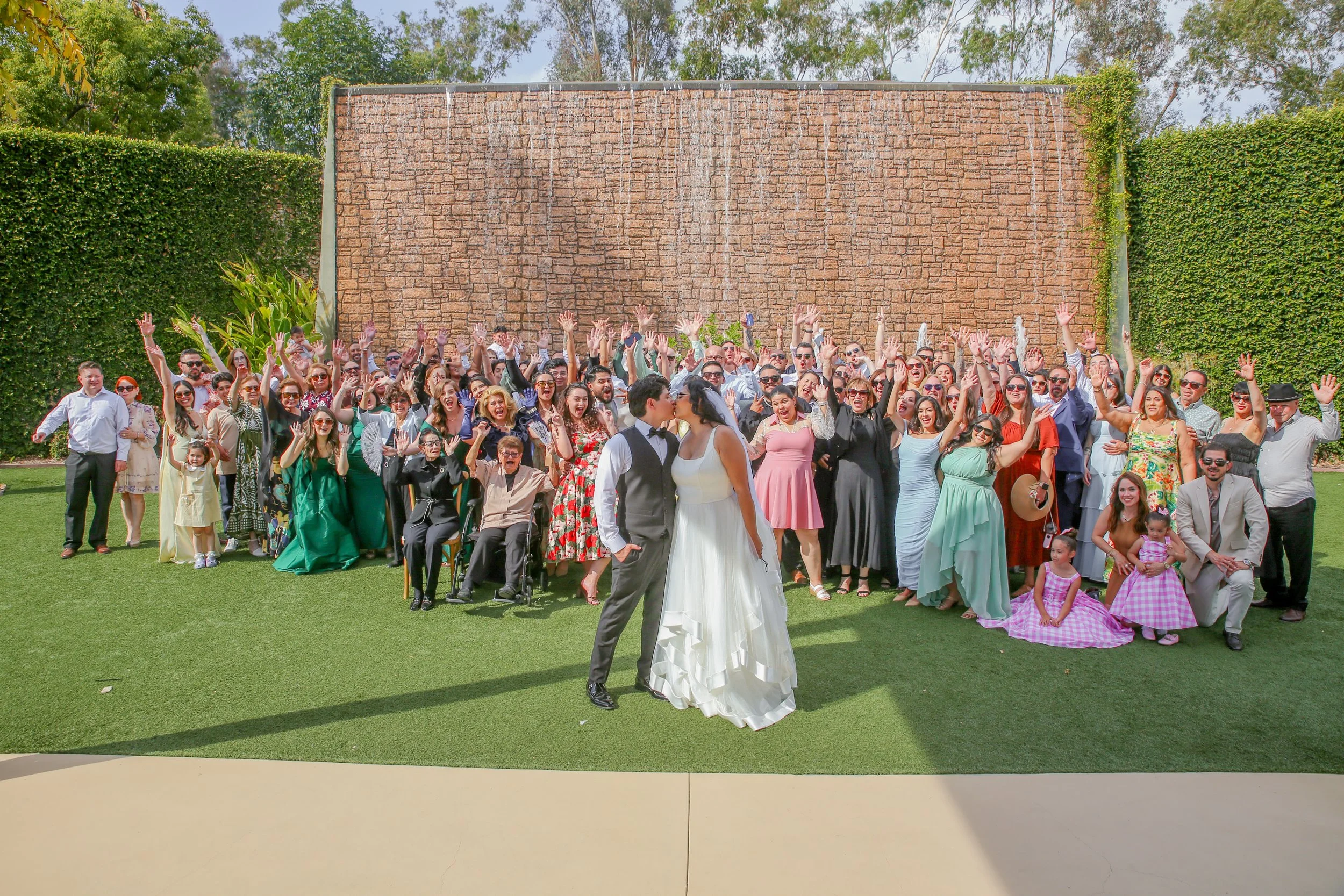 Final wedding group photo with the bride, groom, family, friends, and guests at River Garden Wedding Events in Vista, San Diego.