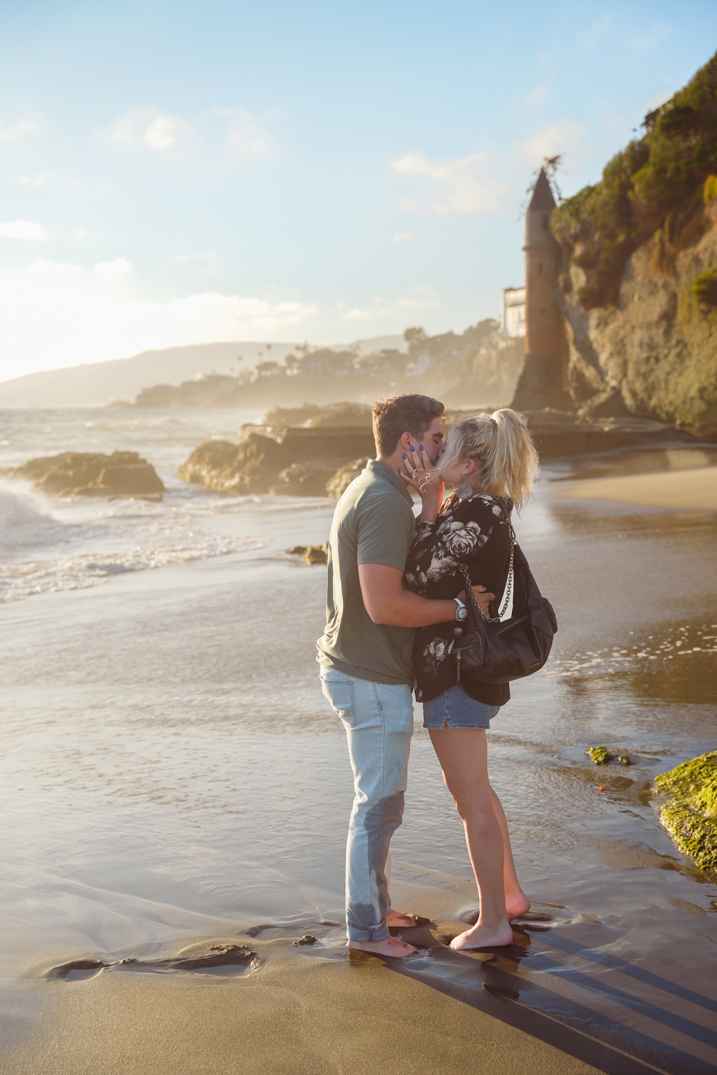Couple shares a quiet engagement moment at Victoria Beach, one of the most picturesque proposal locations in Orange County.
