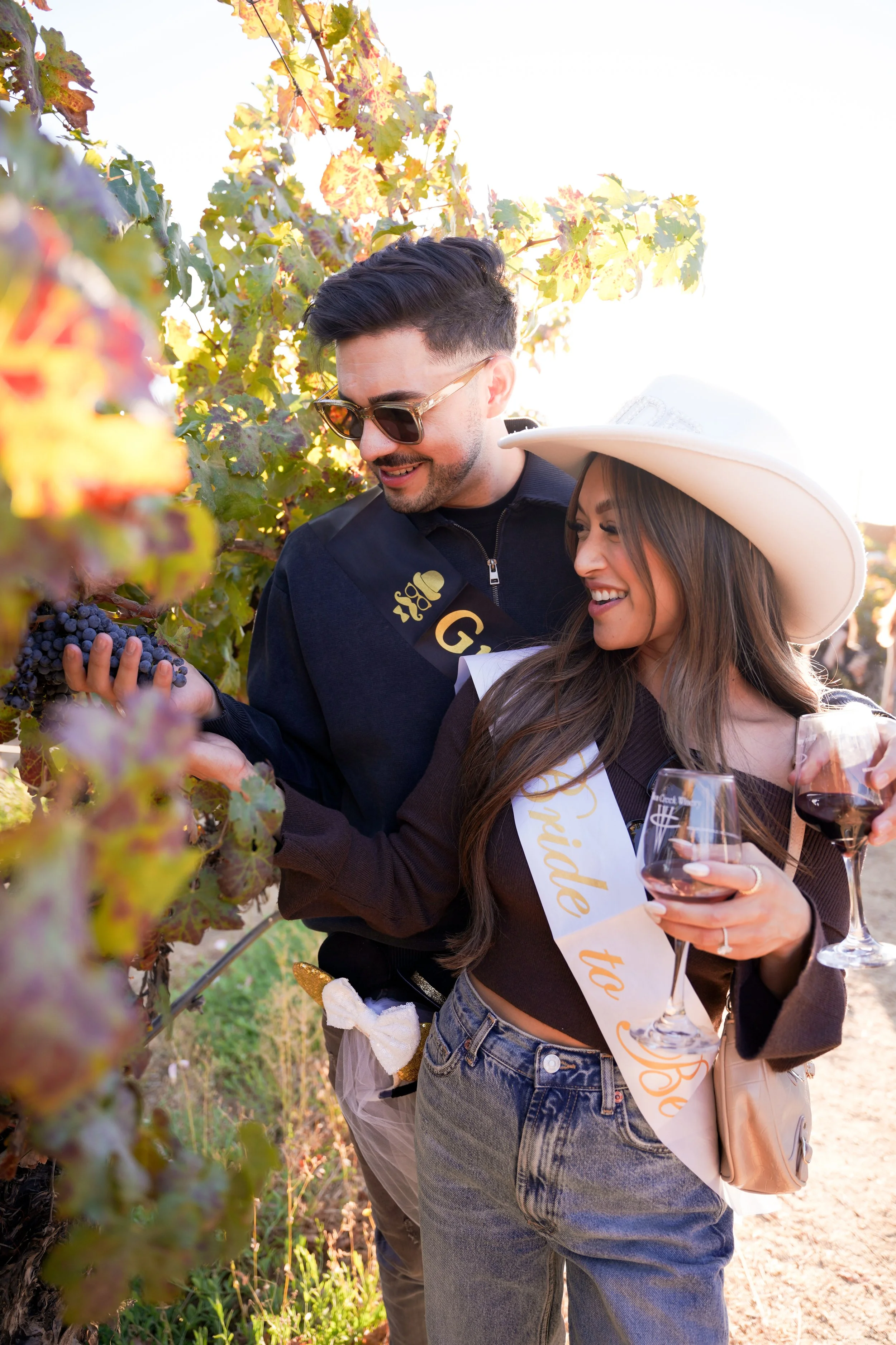 Engaged couple celebrating at Temecula wineries during golden hour – romantic vineyard engagement photography