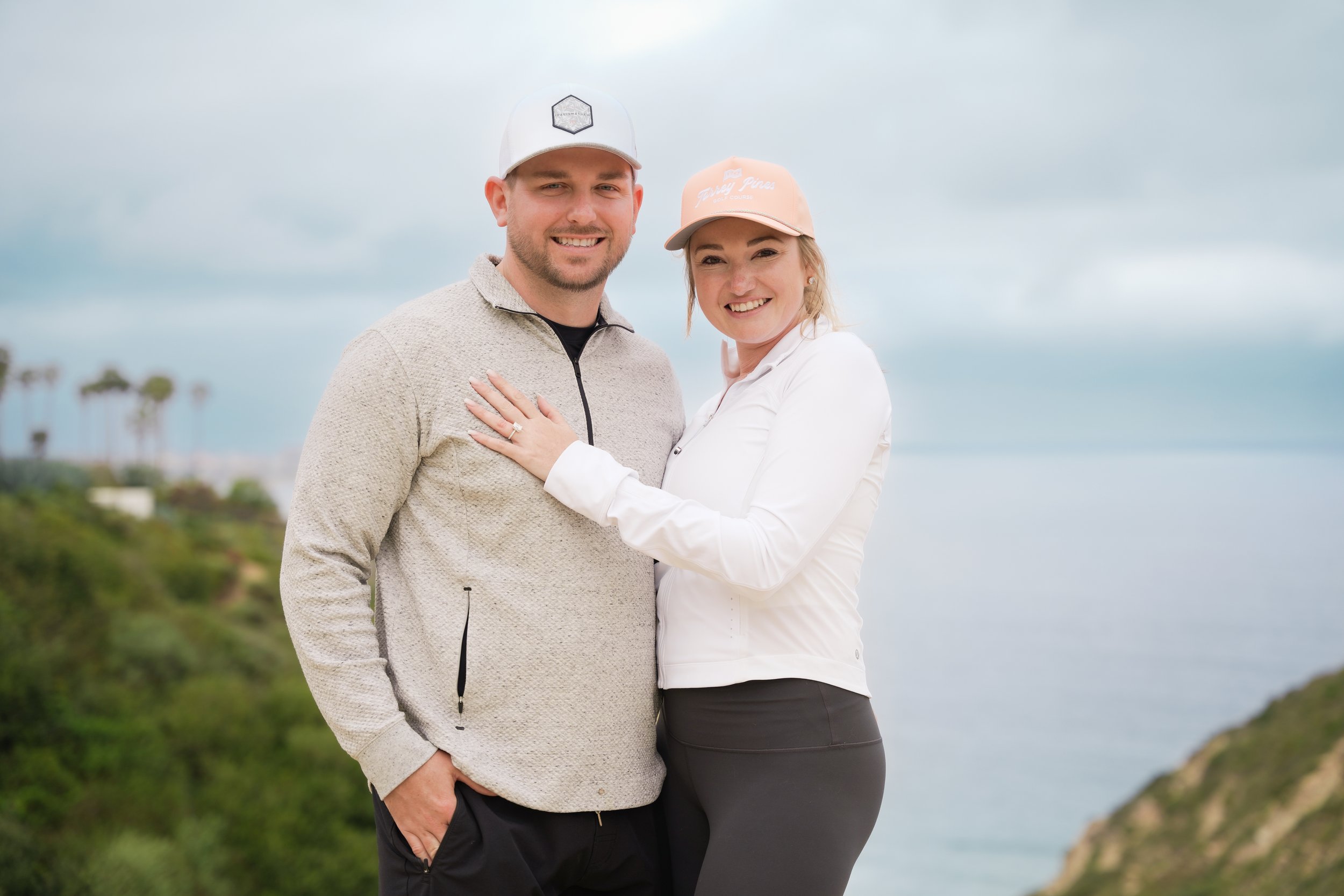 Surprise proposal captured on the Saigon Trail hike in La Jolla, with stunning views of the Pacific Ocean. Book our Undercover Yes Proposal Package for an unforgettable, discreetly captured moment.
