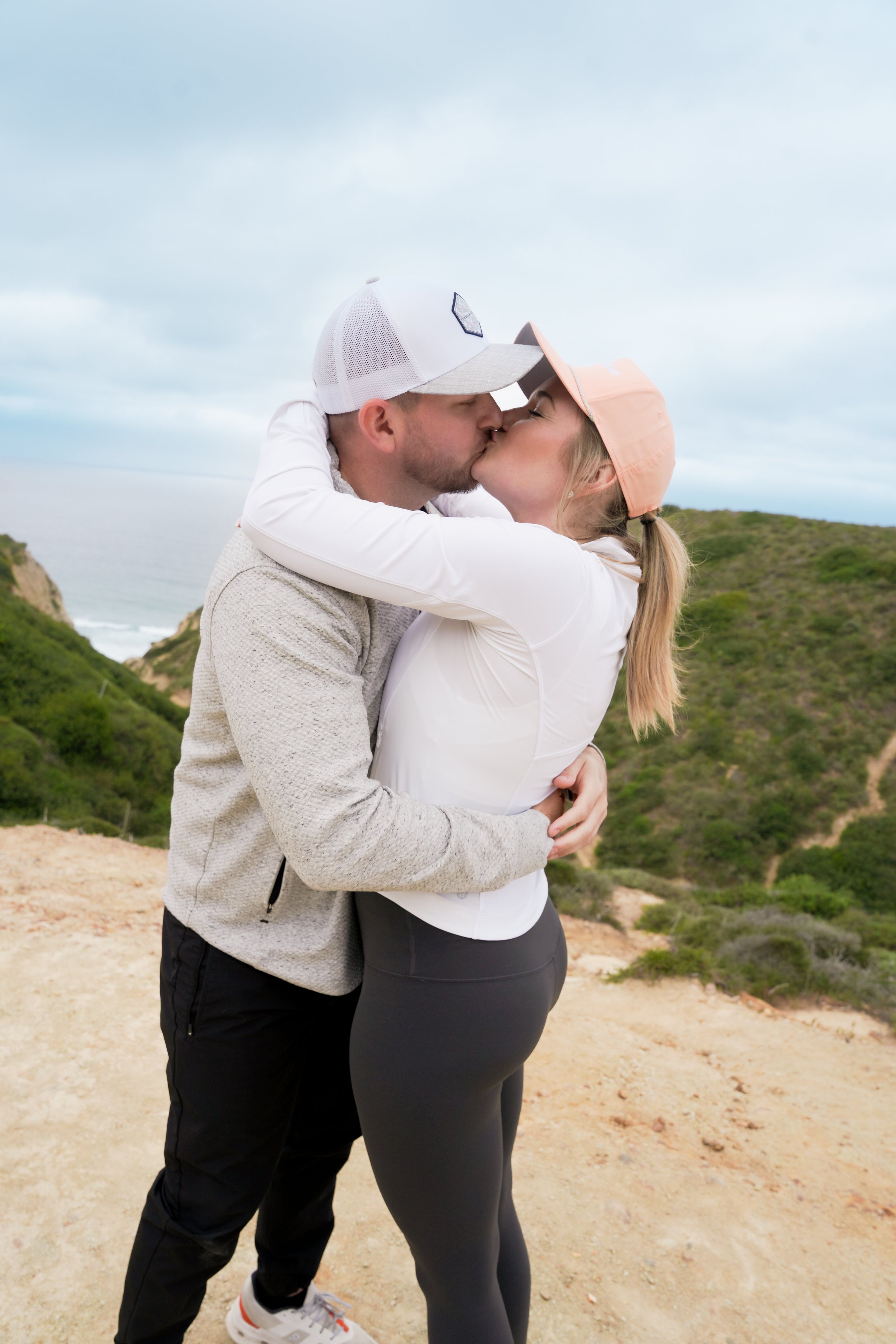Surprise proposal captured on the Saigon Trail hike in La Jolla, with stunning views of the Pacific Ocean. Book our Undercover Yes Proposal Package for an unforgettable, discreetly captured moment.