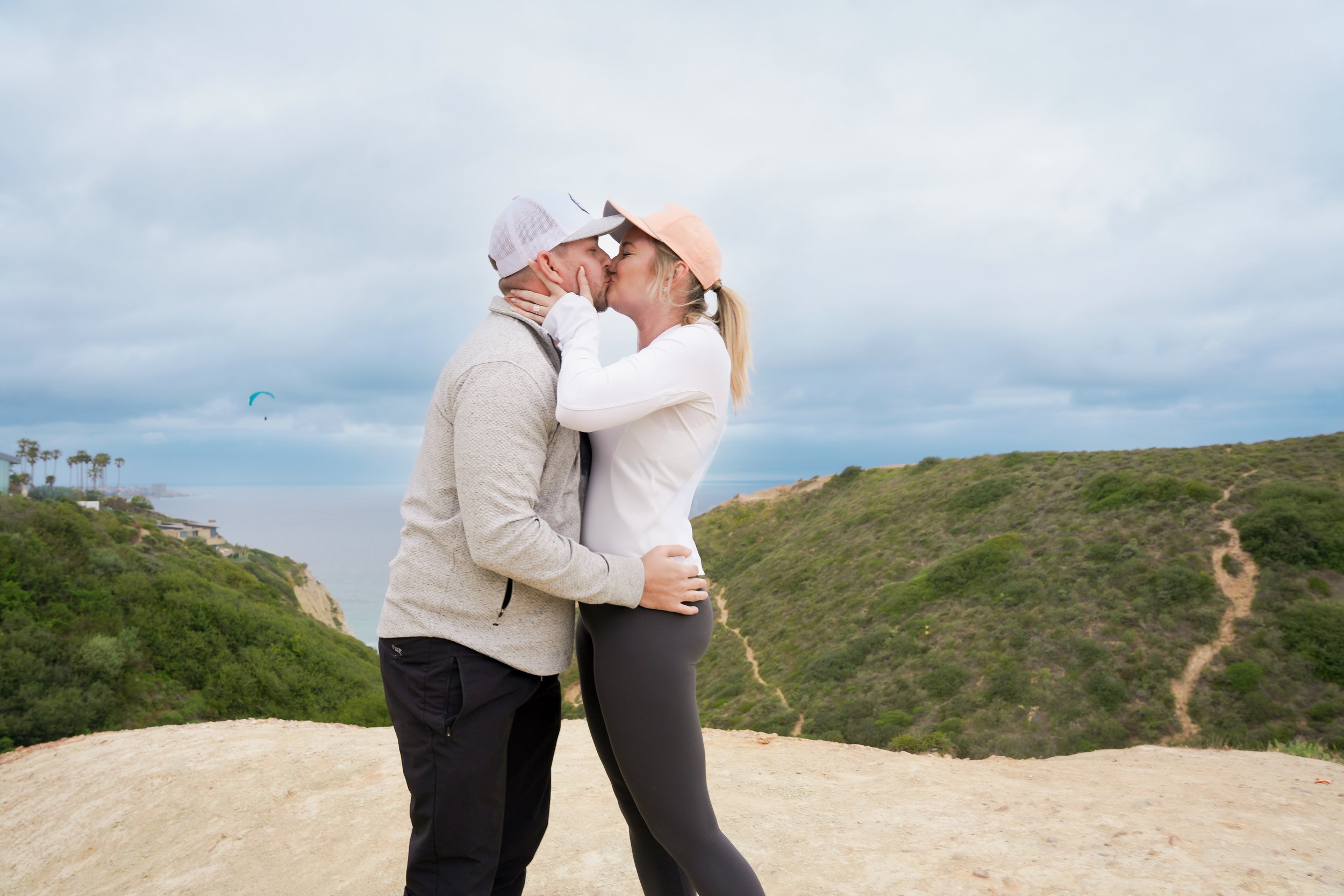 Surprise proposal captured on the Saigon Trail hike in La Jolla, with stunning views of the Pacific Ocean. Book our Undercover Yes Proposal Package for an unforgettable, discreetly captured moment.