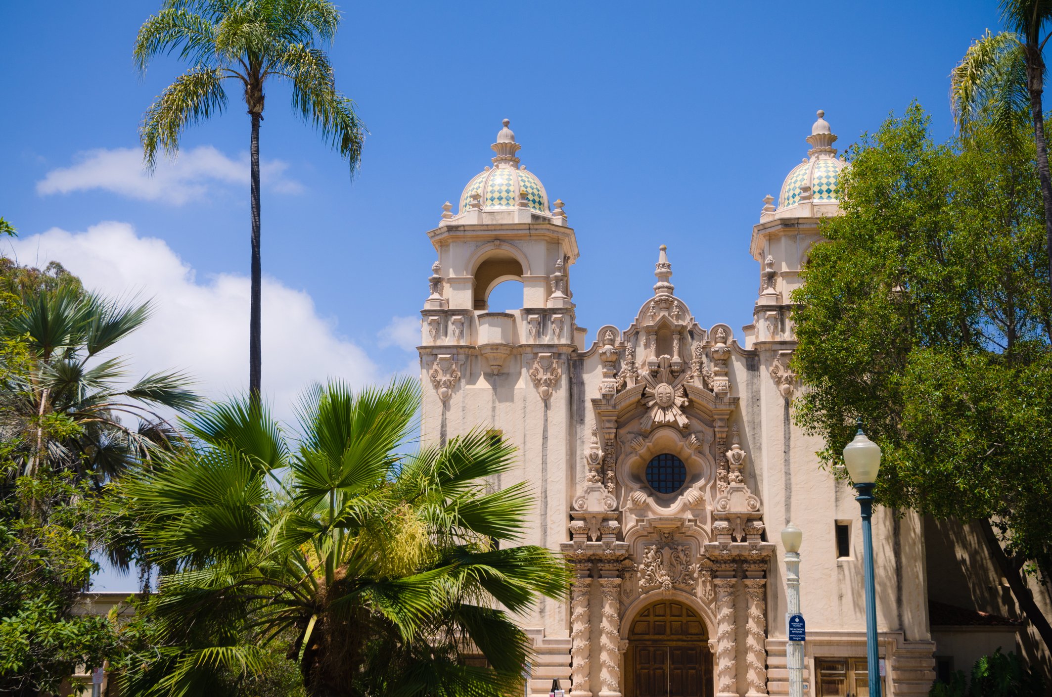 Balboa Park in San Diego featuring historic Spanish-style architecture, lush gardens, and golden hour light filtering through the trees—perfect for timeless portraits and candid moments. Book your Balboa Park milestone or couples session today.