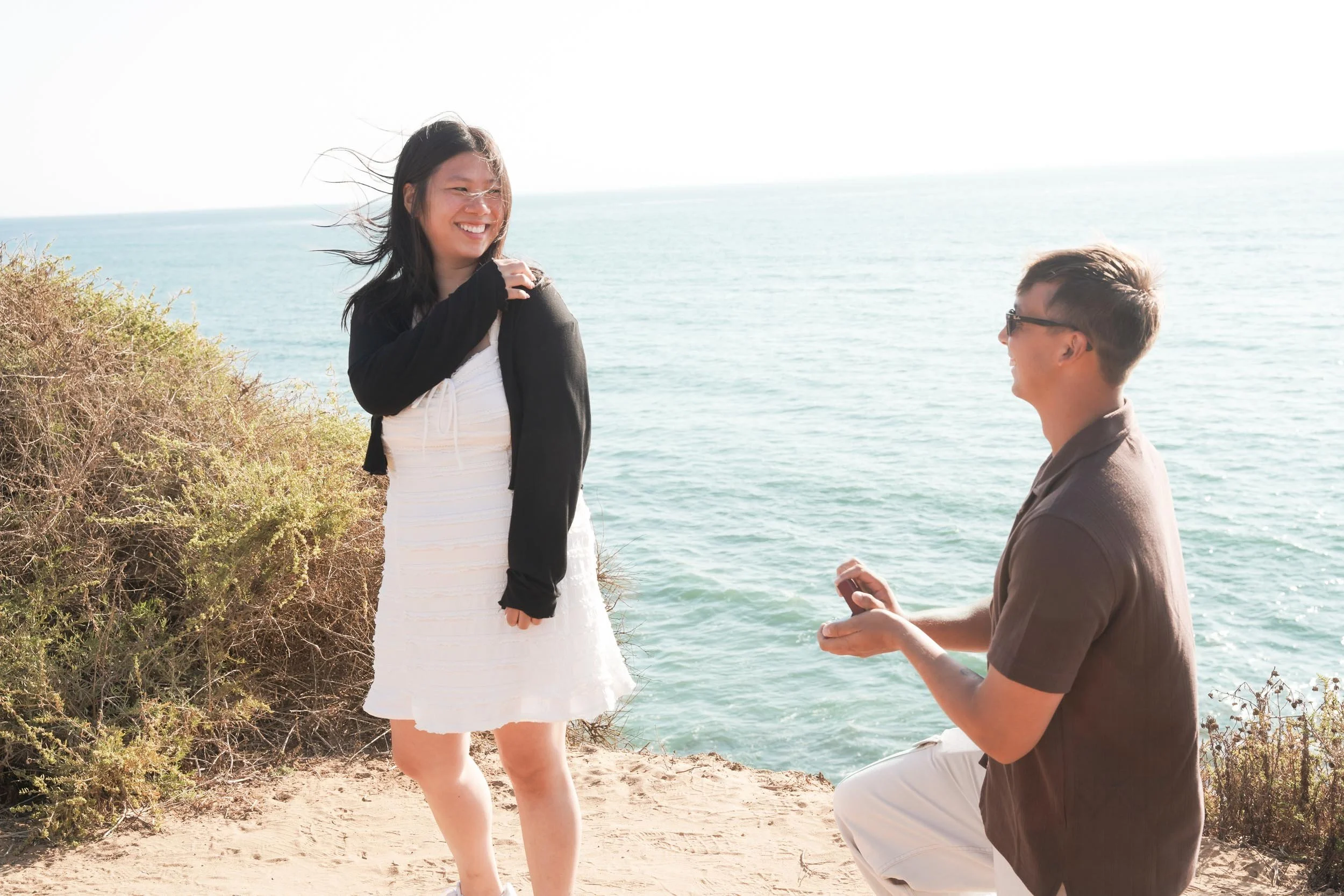 Professional San Diego proposal photographer capturing a Sunset Cliffs engagement with golden hour light and ocean cliffside backdrops.