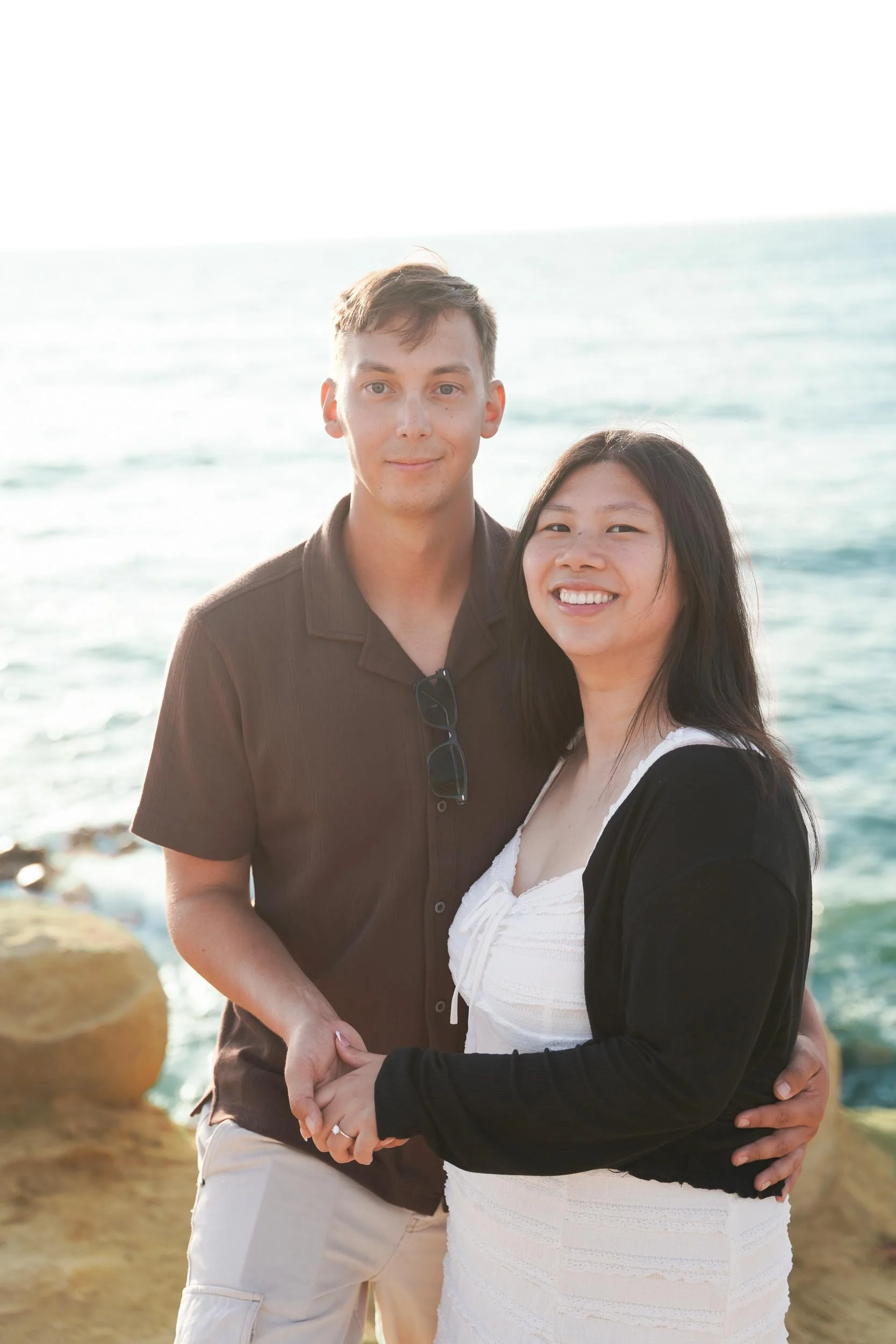Engagement proposal photography at Sunset Cliffs San Diego with golden hour portraits and candid post-proposal celebration by the ocean.
