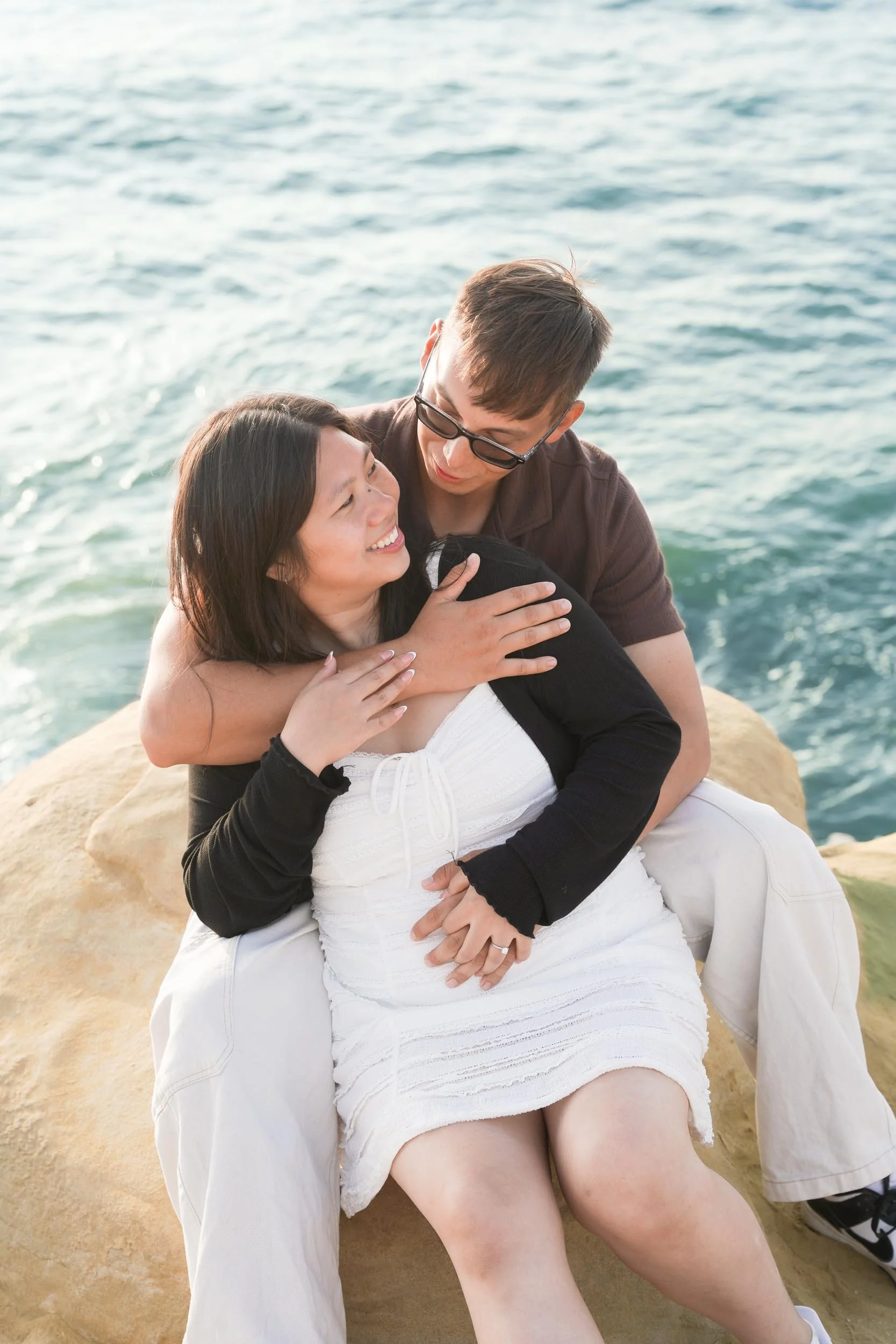 Romantic Sunset Cliffs surprise proposal photography in San Diego highlighting golden hour engagement photos and candid emotional reactions.