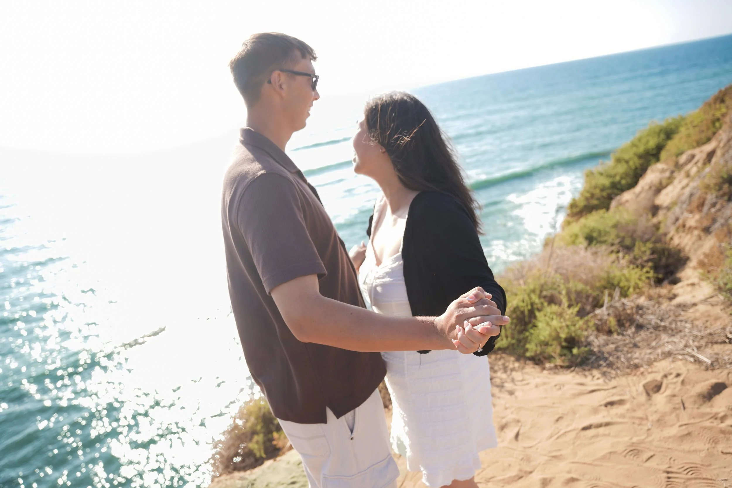 Last-minute Sunset Cliffs proposal photography in San Diego capturing the surprise, golden hour portraits, and professional engagement photos.
