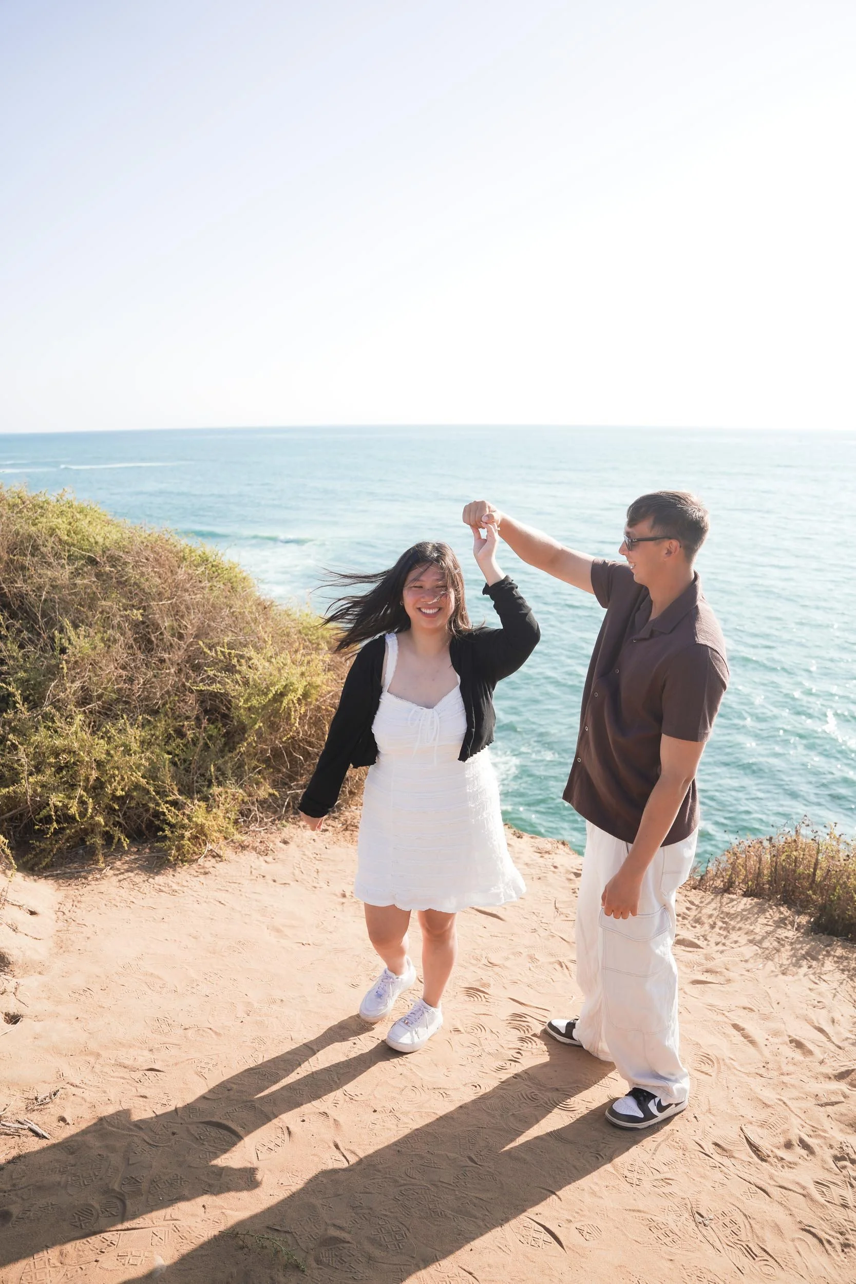 San Diego engagement and proposal photography at Sunset Cliffs with sweeping ocean views and candid golden hour portraits of the couple.