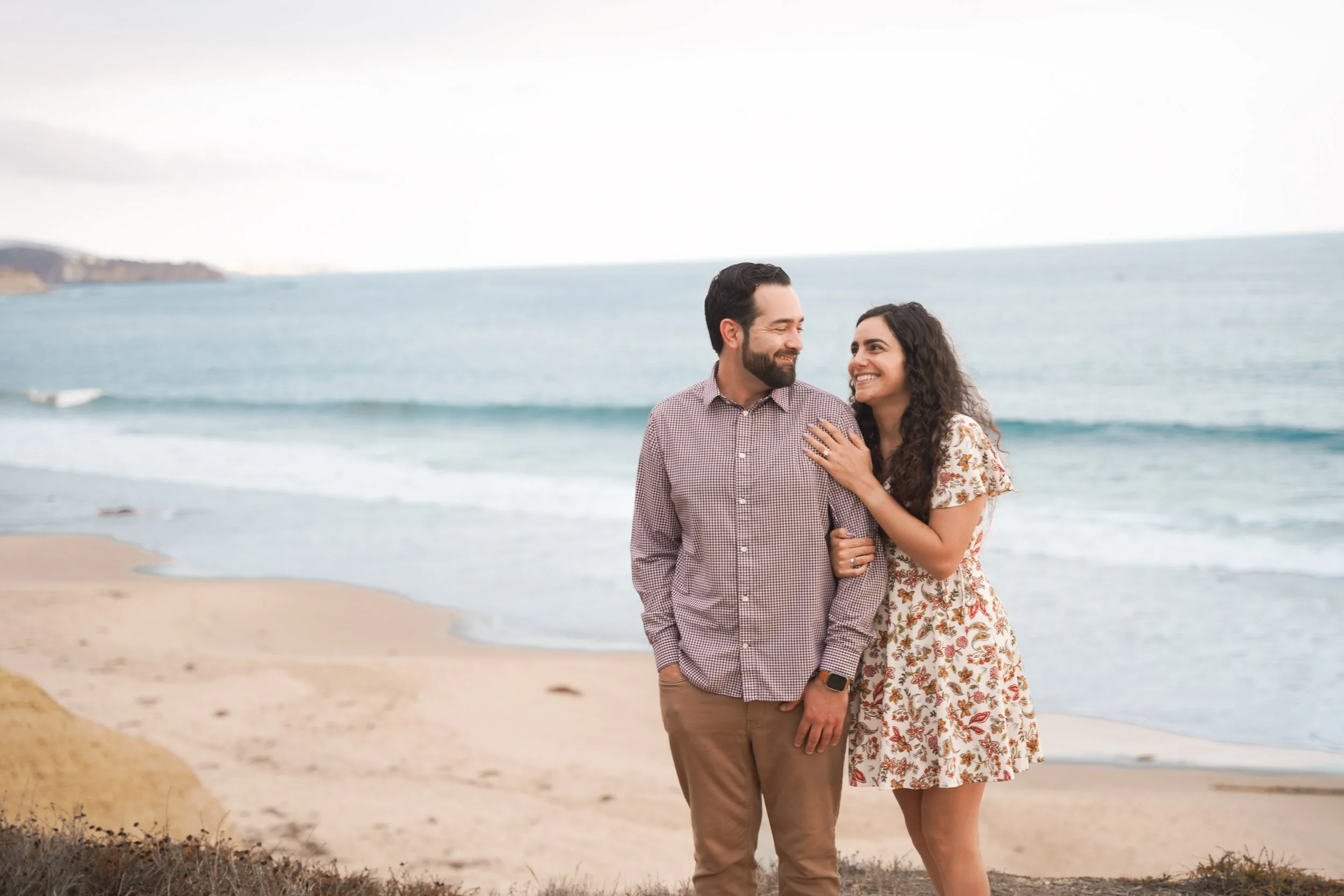 Candid proposal moments captured at Crystal Cove in Newport Beach — hire expert photographers for your engagement.