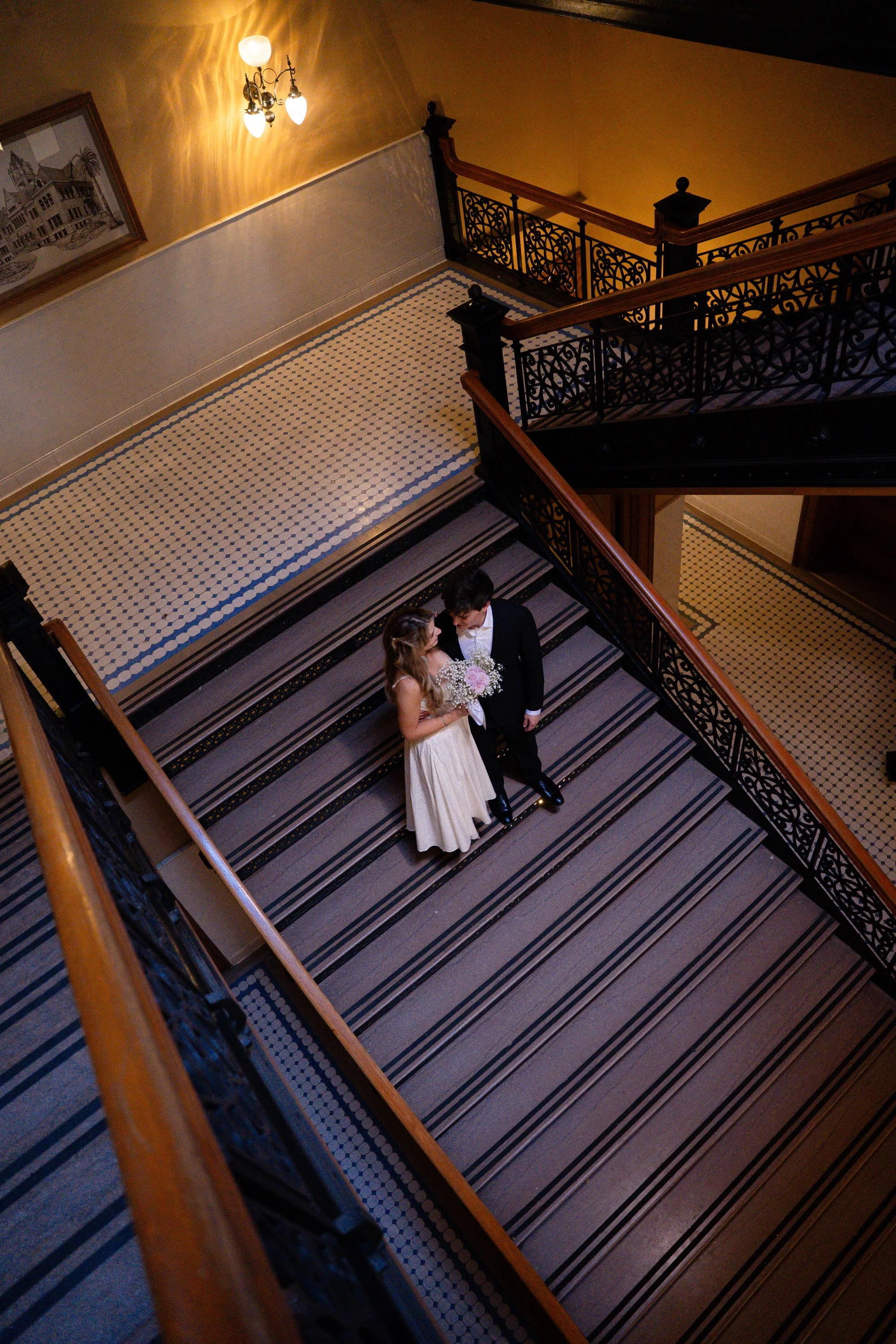 Couple Standing on Grand Staircase Inside OC Courthouse
