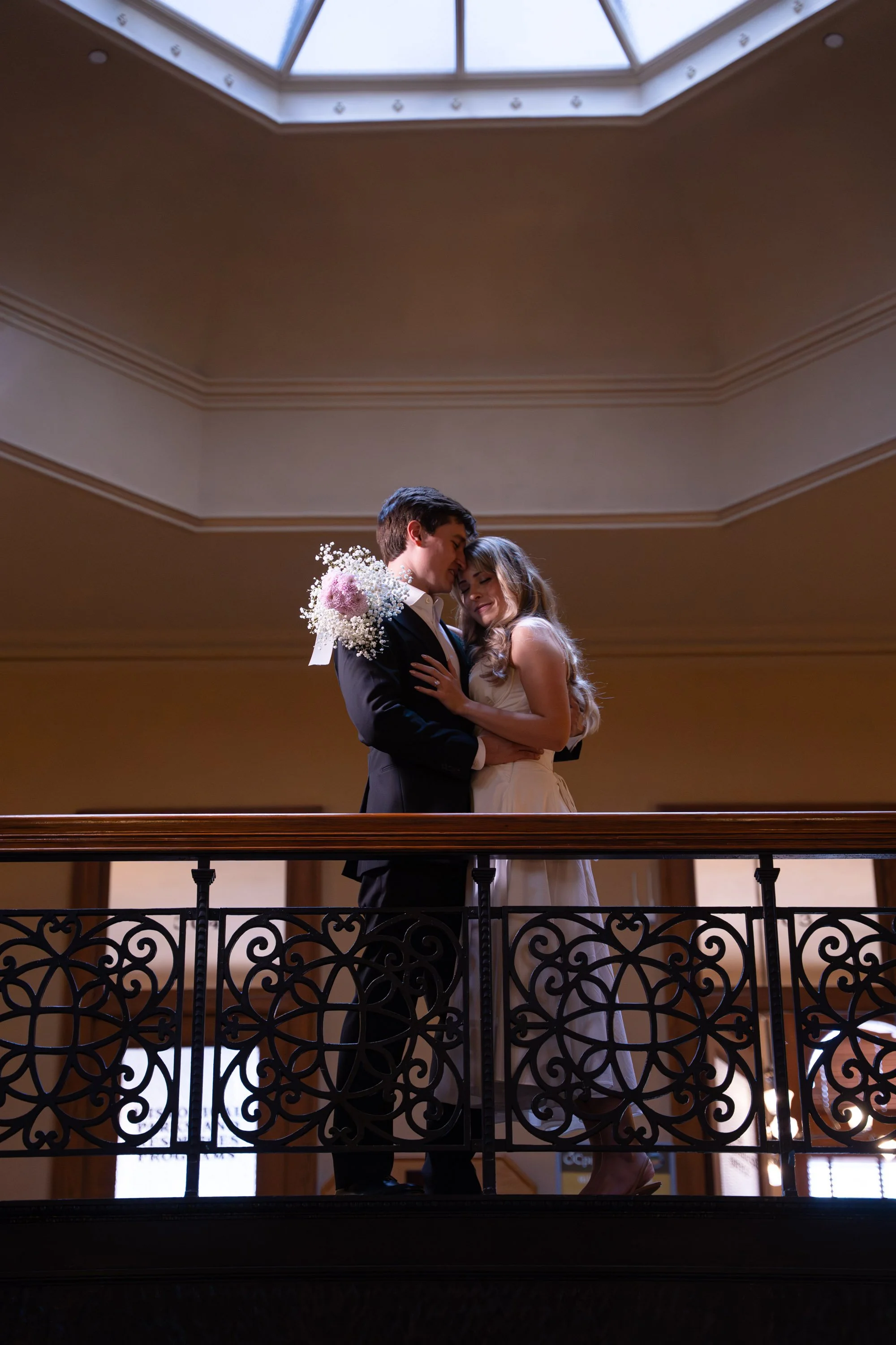 Couple Leaning on Second Floor Rail Inside Courthouse