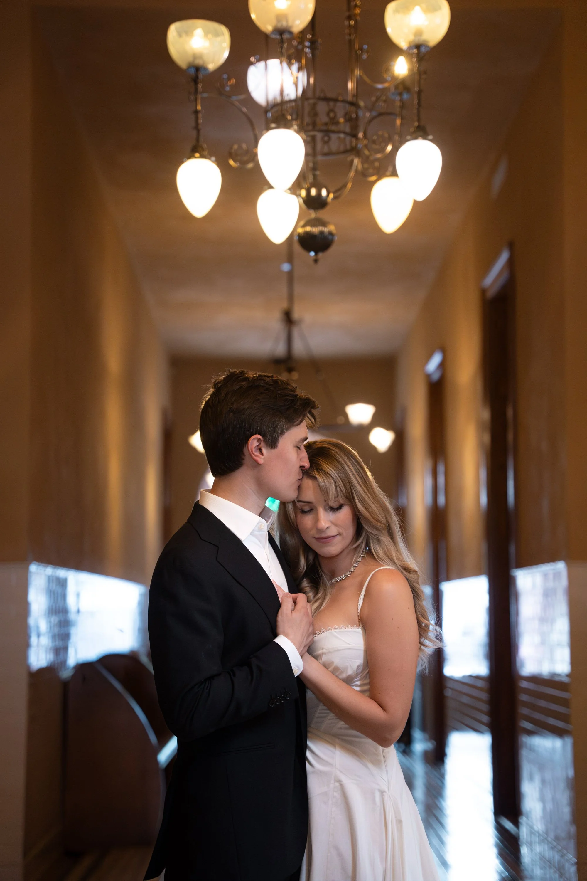Couple Embracing in Historic Courthouse Hallway