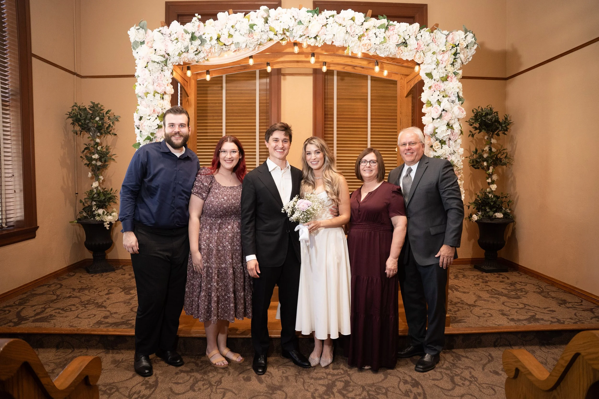 Family Embrace Inside Courthouse Chapel After Vows