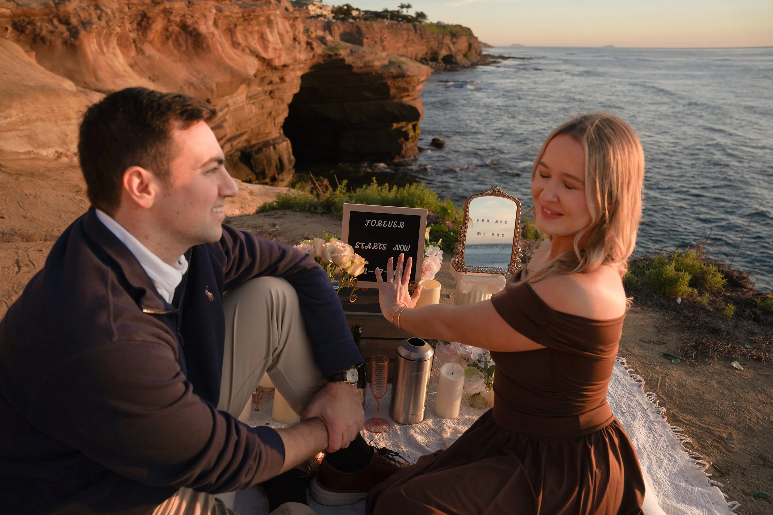 Coastal surprise proposal during golden hour