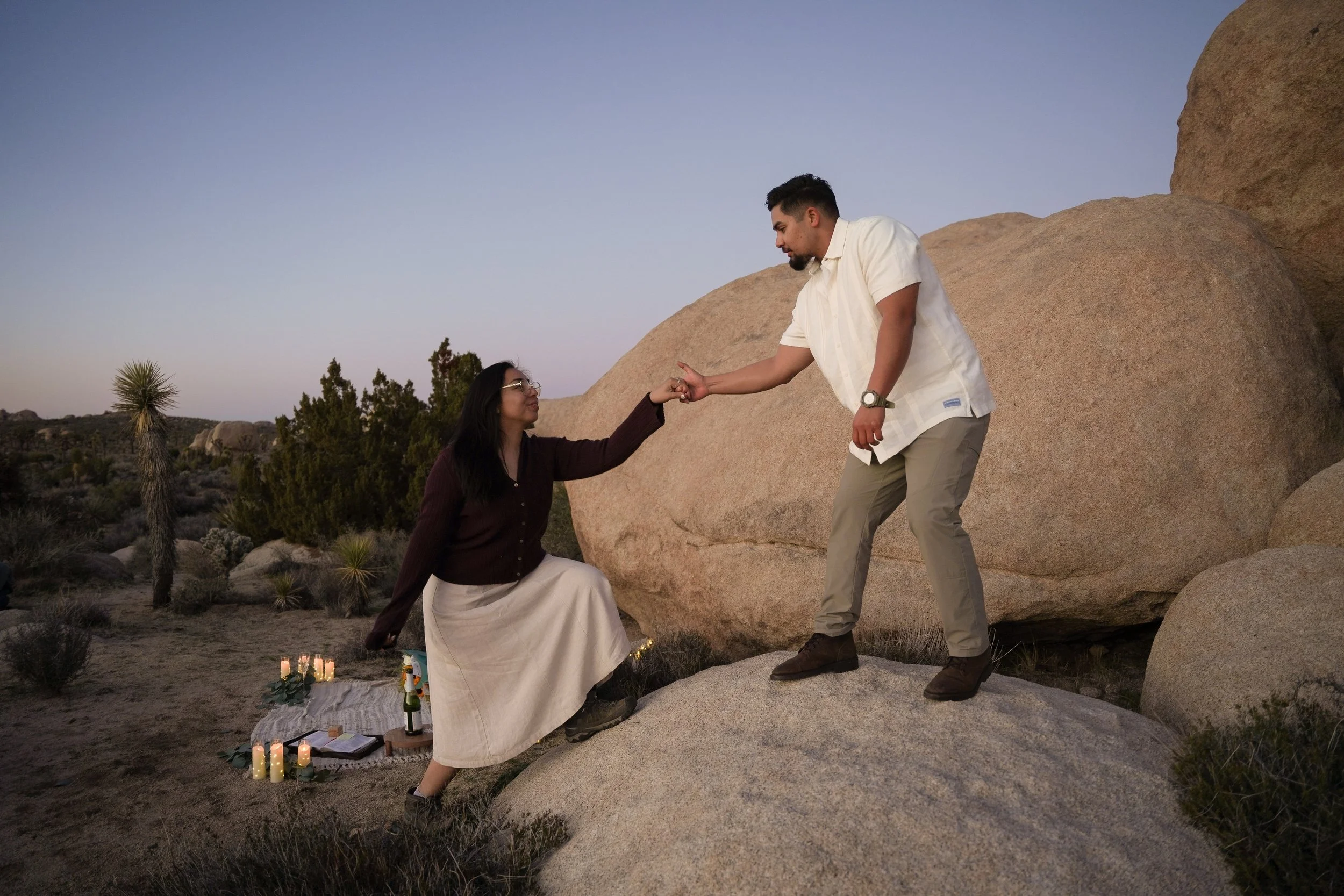 Joshua Tree Engagement Helping Her Up Boulder