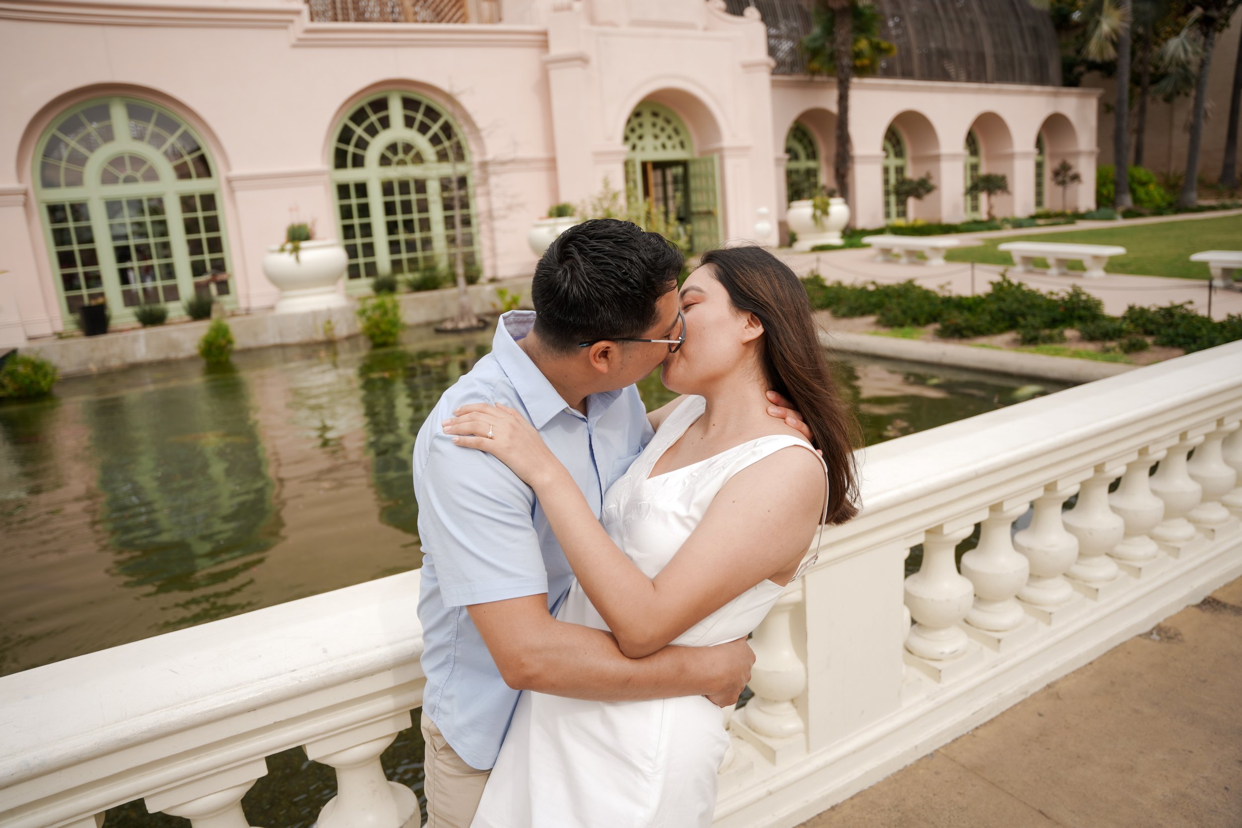 Post proposal engagement portraits at the Lily Pond and Botanical Building in Balboa Park San Diego after a Japanese Friendship Garden surprise proposal