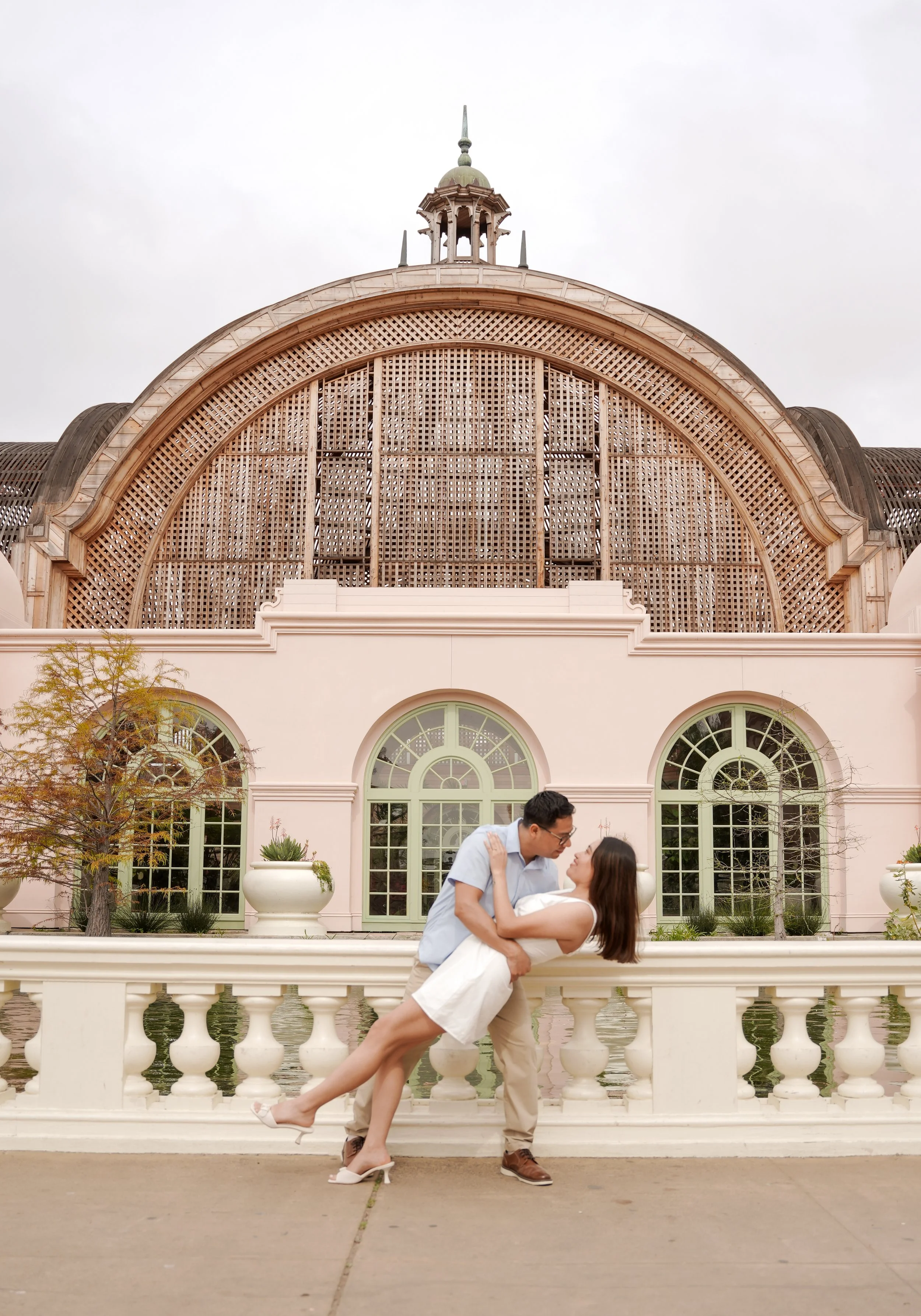 Romantic engagement photos on the pedestrian bridge near the Botanical Building in Balboa Park San Diego after a surprise proposal