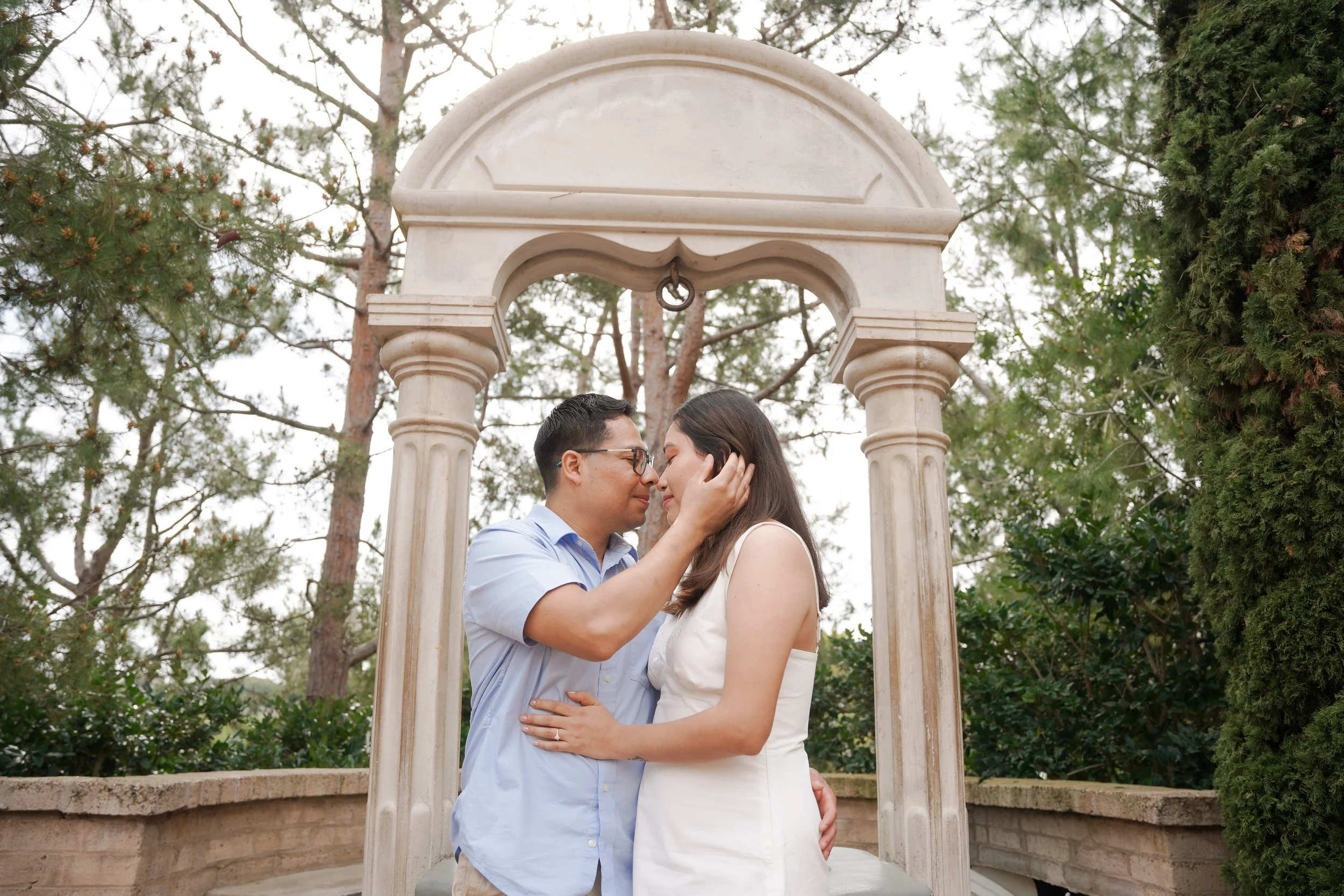 Newly engaged couple taking portraits at the Pavilion in Balboa Park after a surprise proposal photoshoot in San Diego