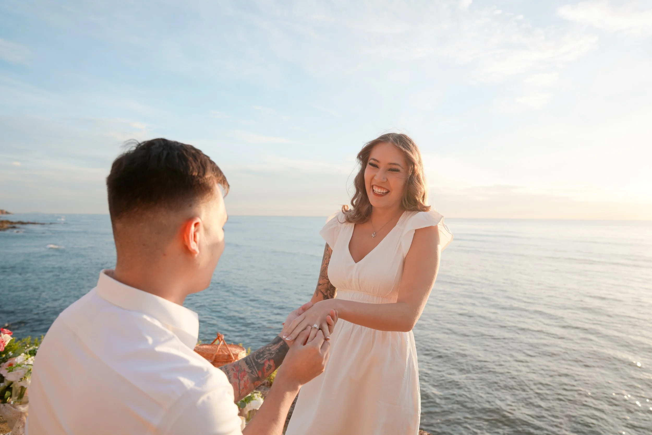 Romantic Coastal Engagement Moment at Sunset