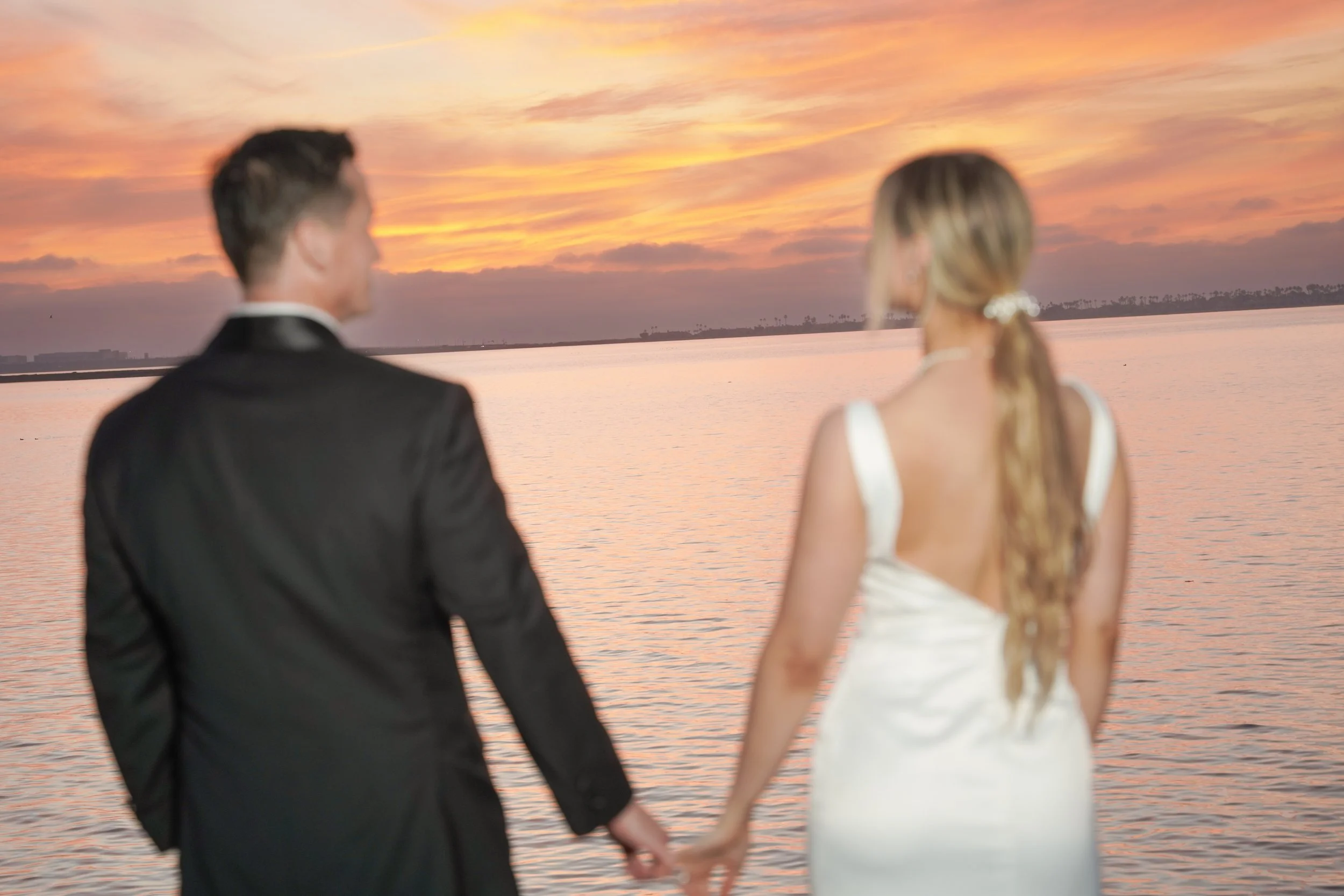Bride and Groom Holding Hands Watching the Sunset After Courthouse Wedding