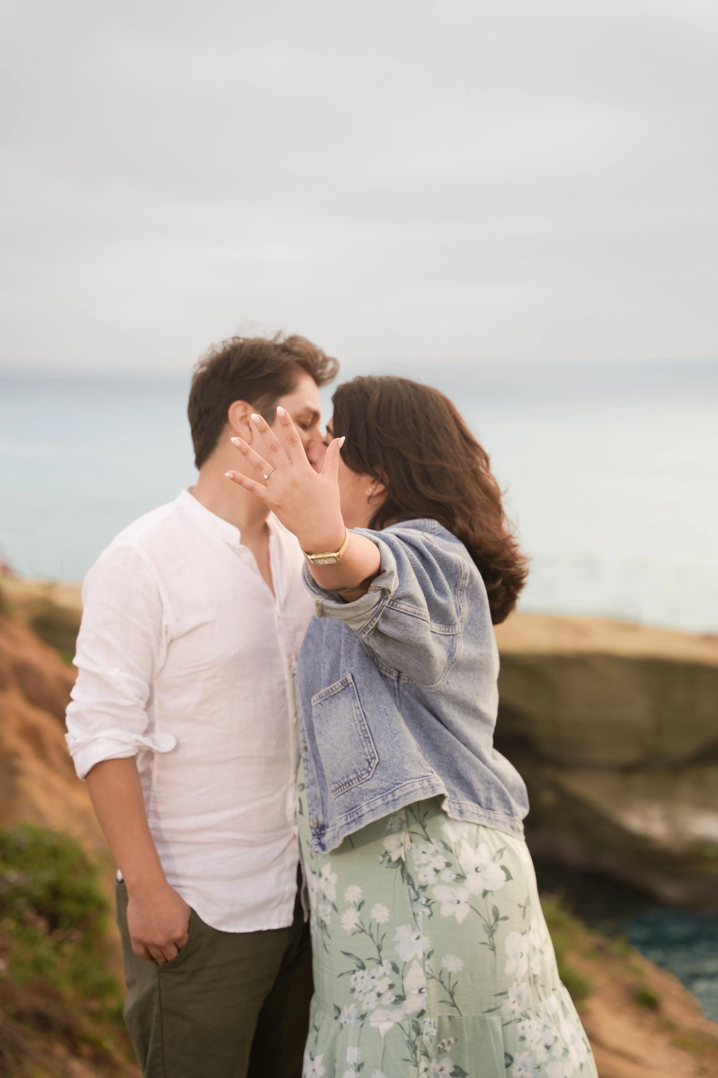 Sunset Cliffs engagement photo at golden hour with couple holding hands