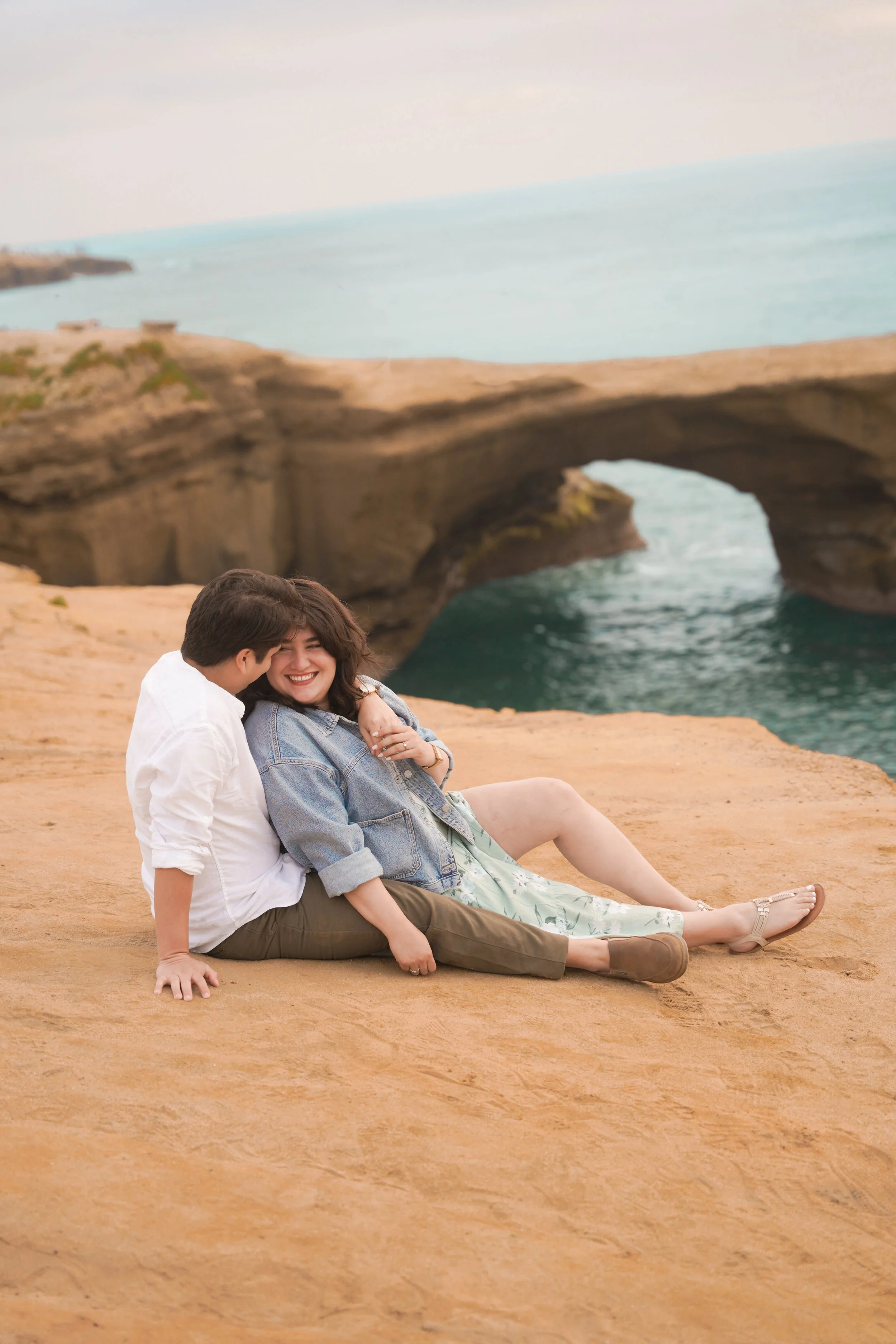 Romantic engagement photo at Sunset Cliffs with ocean sunset backdrop