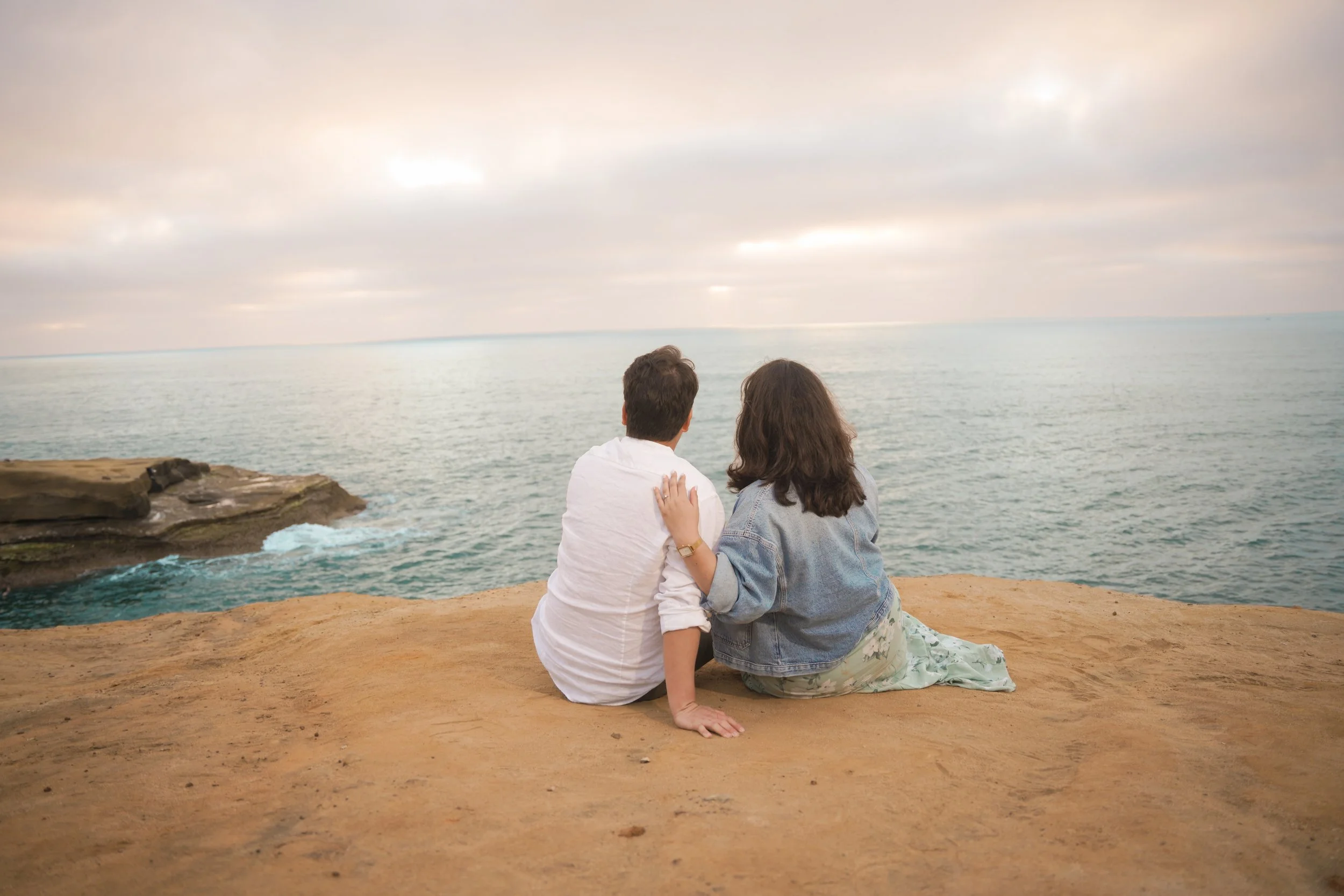 Candid couple moment at Sunset Cliffs during coastal sunset session